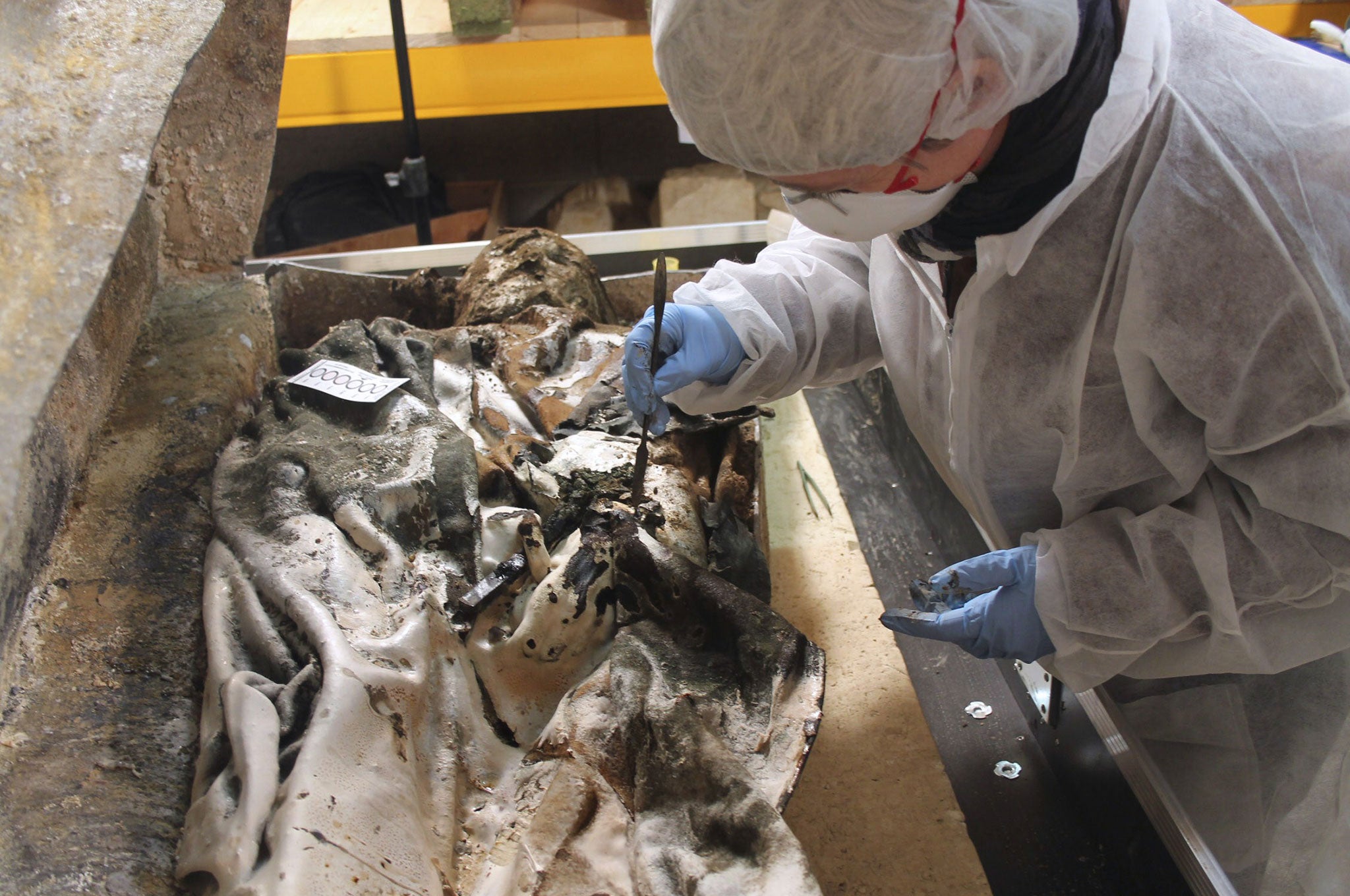 From the French National Institute, an archaeologist works in Rennes during the opening of a lead coffin of a noble woman from the XVII century