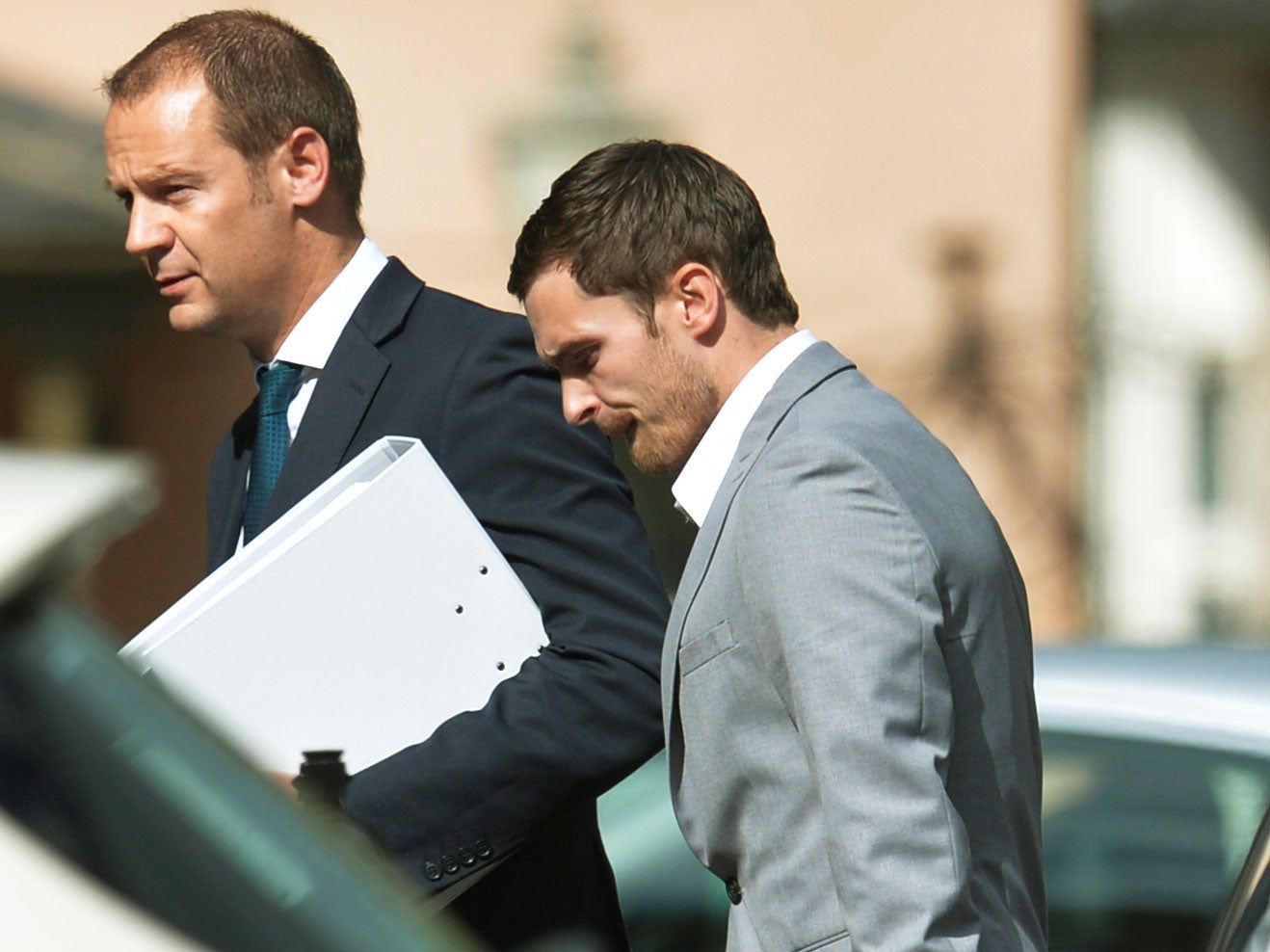 England and Sunderland footballer Adam Johnson (right)
arrives at Durham Crown Court where he pleaded not guilty to three counts of sexual activity with a girl under 16 and one of grooming