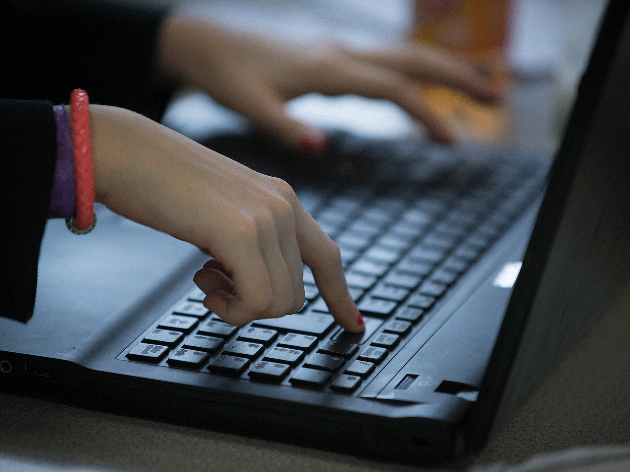 A pupil uses a laptop computer during an English lesson