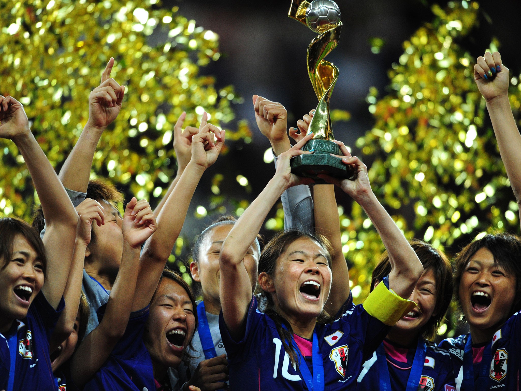 Japan’s players celebrate with the trophy after the FIFA Women's Football World Cup final in 2011