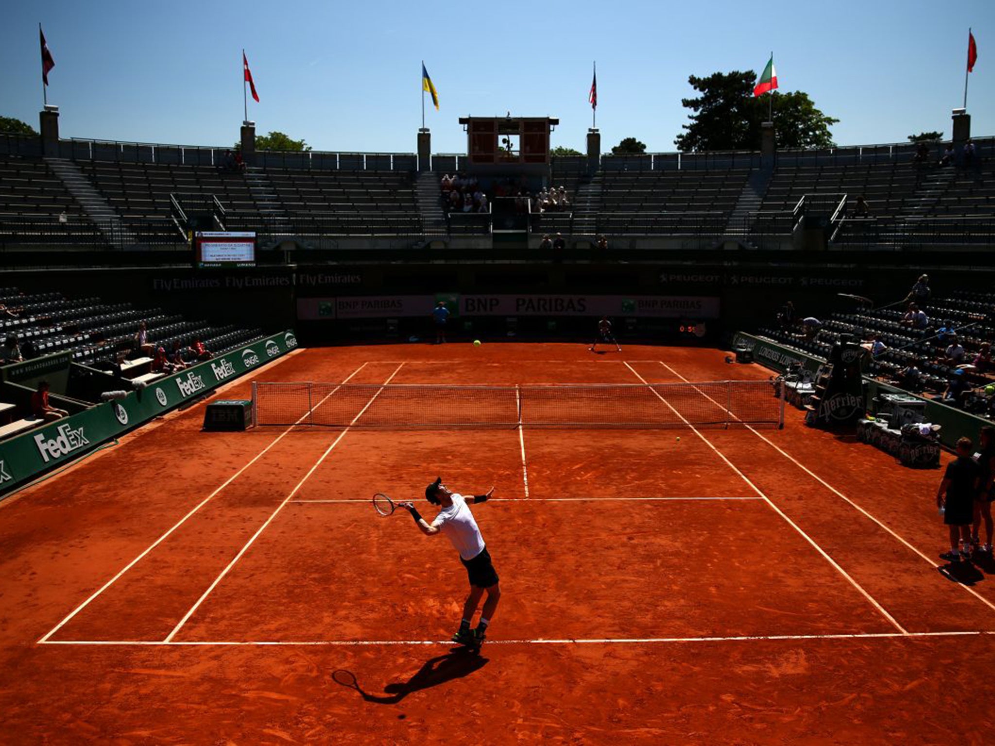 Andy Murray in mid-serve during a practice session at Roland Garros on Thursday