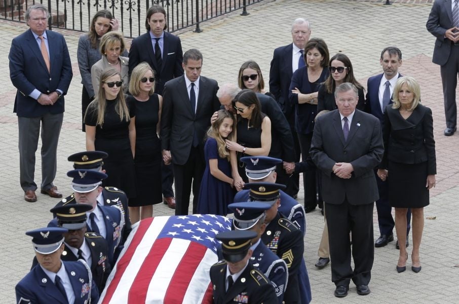 Natalie Biden, center, is comforted by her grandfather, Vice President Joe Biden, and her mother Hallie