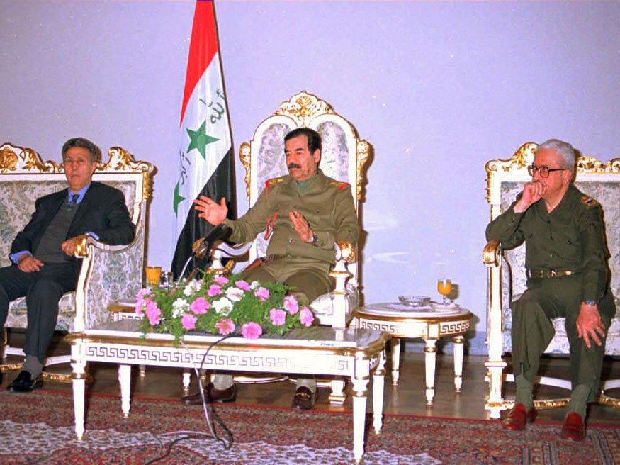 Saddam Hussein meets members of the Madrid International Court in 1997 with his then Deputy Prime Minister Tariq Aziz (R)