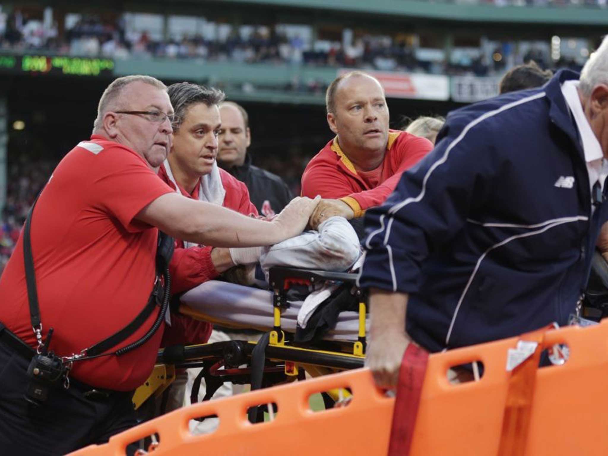 The injured spectator is wheeled off the field