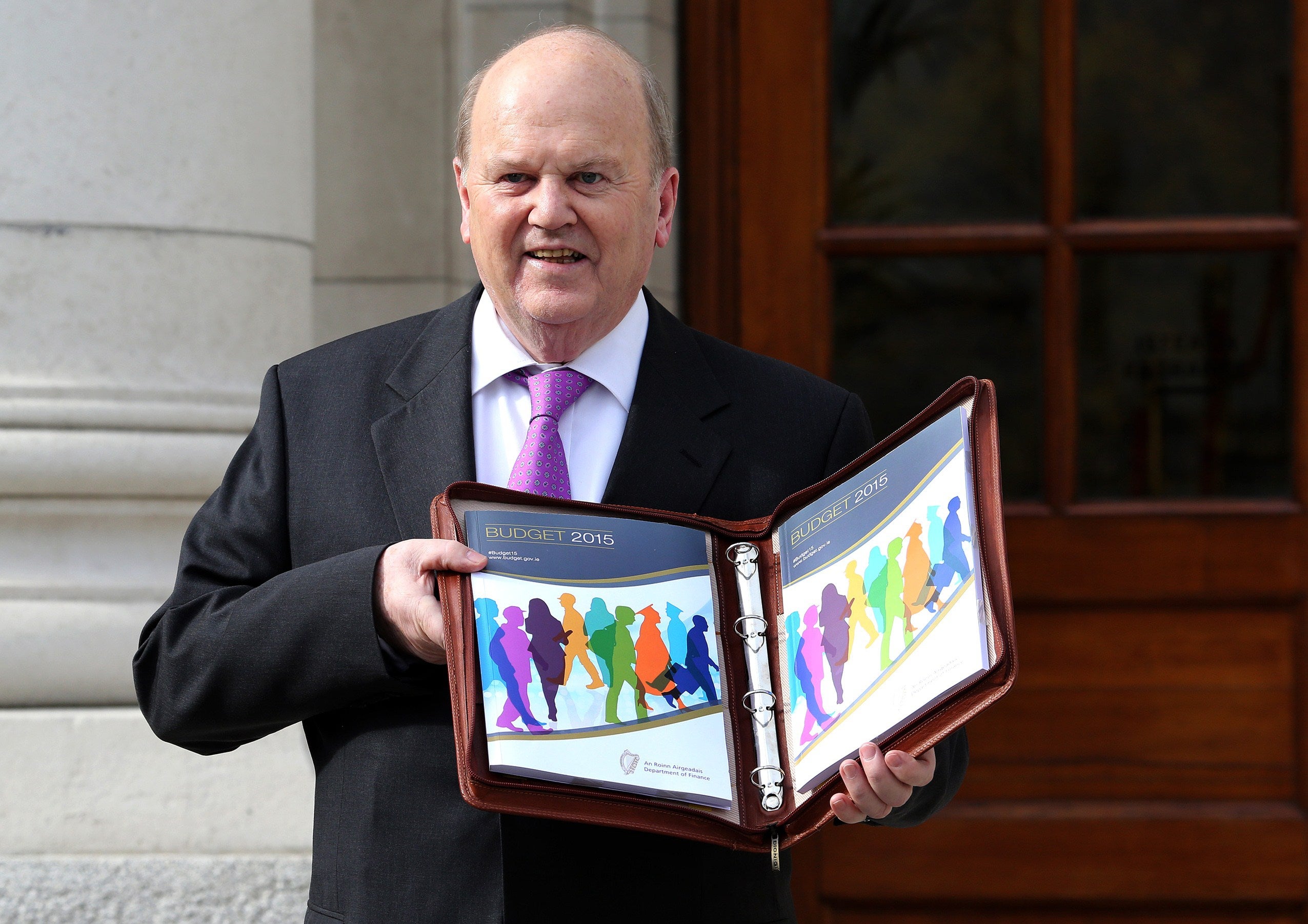 Irish Finance Minister Michael Noonan holds the 2015 budget, which will phase out the 'Double Irish' tax scheme over the next five years
