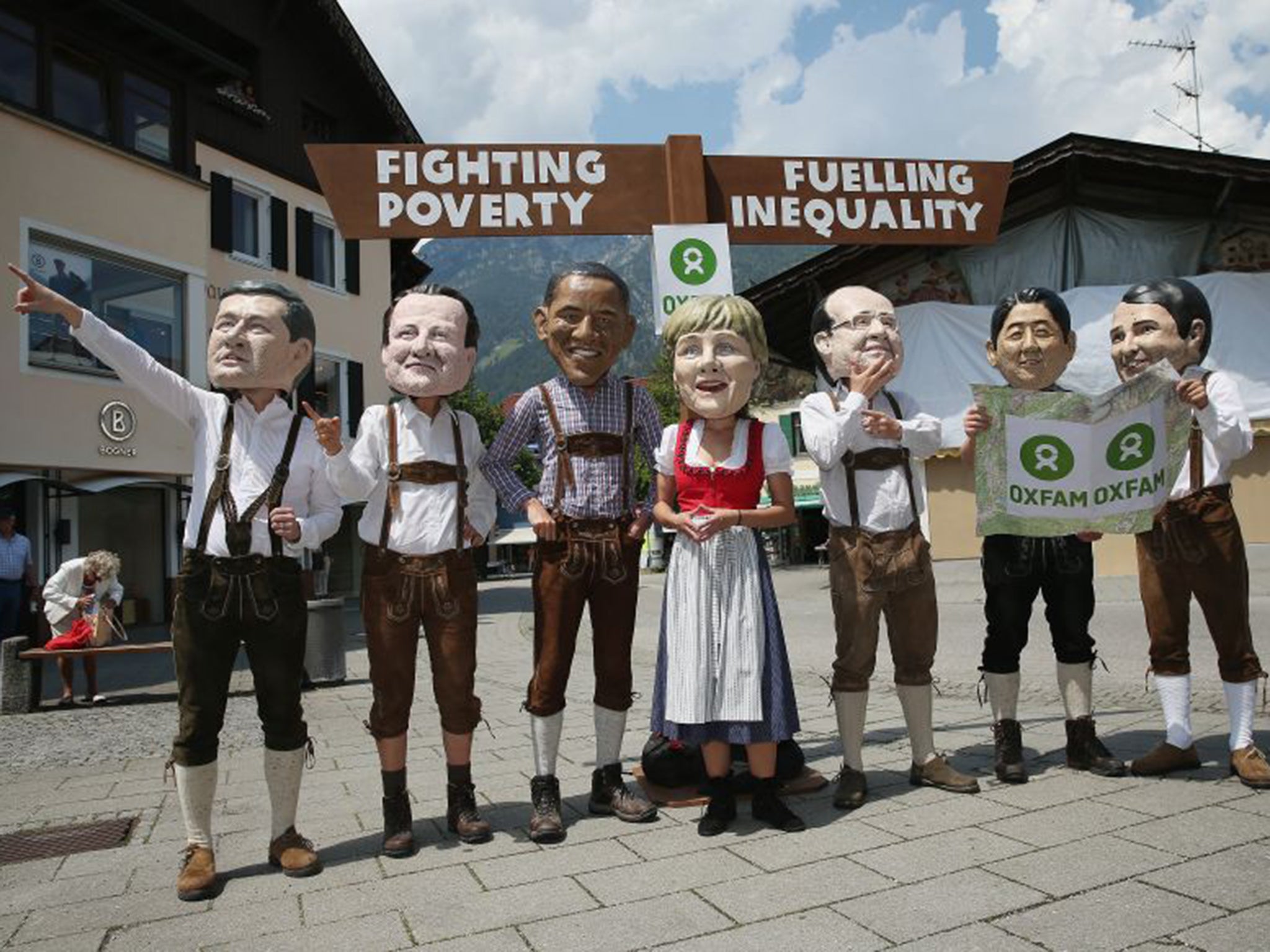 Protesters from Oxfam dressed as the G7 leaders make their point in Garmisch-Partenkirchen on Saturday