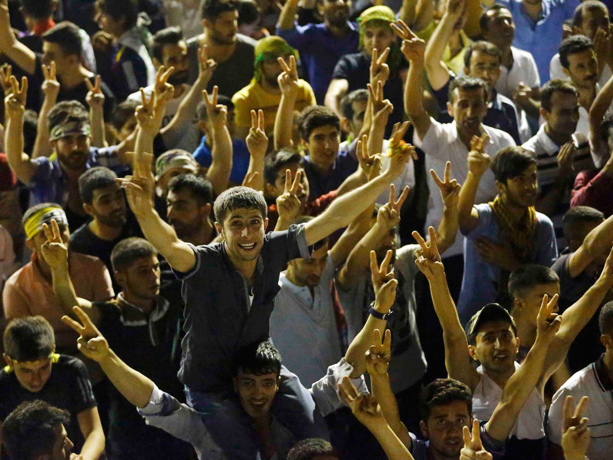 Supporters celebrate outside the pro-Kurdish Peoples' Democratic Party (HDP) headquarters