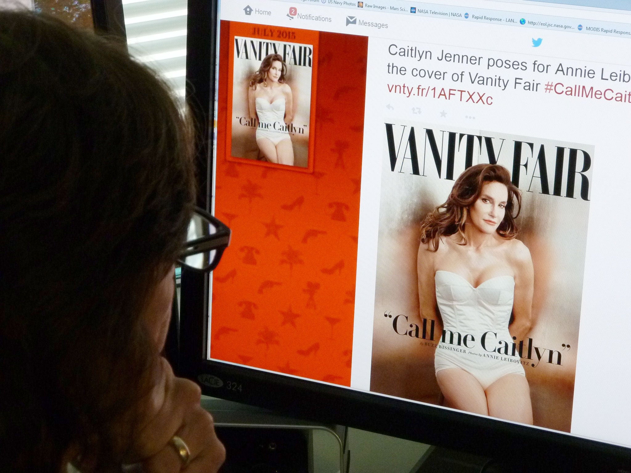 A journalist looks at Vanity Fair's Twitter site with the Tweet about Caitlyn Jenner