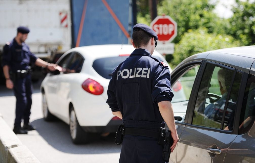 Austrian Police officers check cars near the town of Telfs