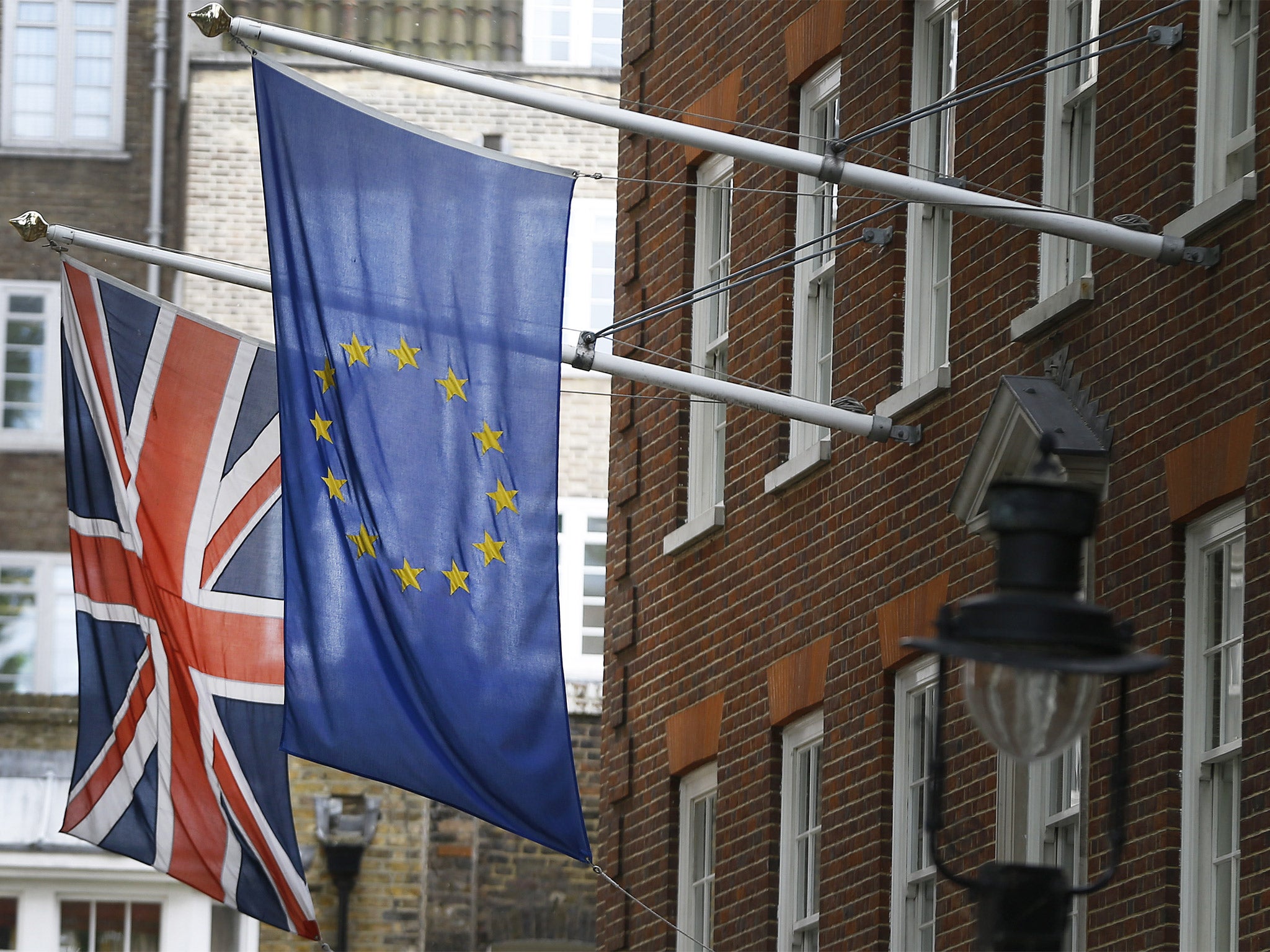 The Union flag and the European Union flag fly outside Europe House, in London