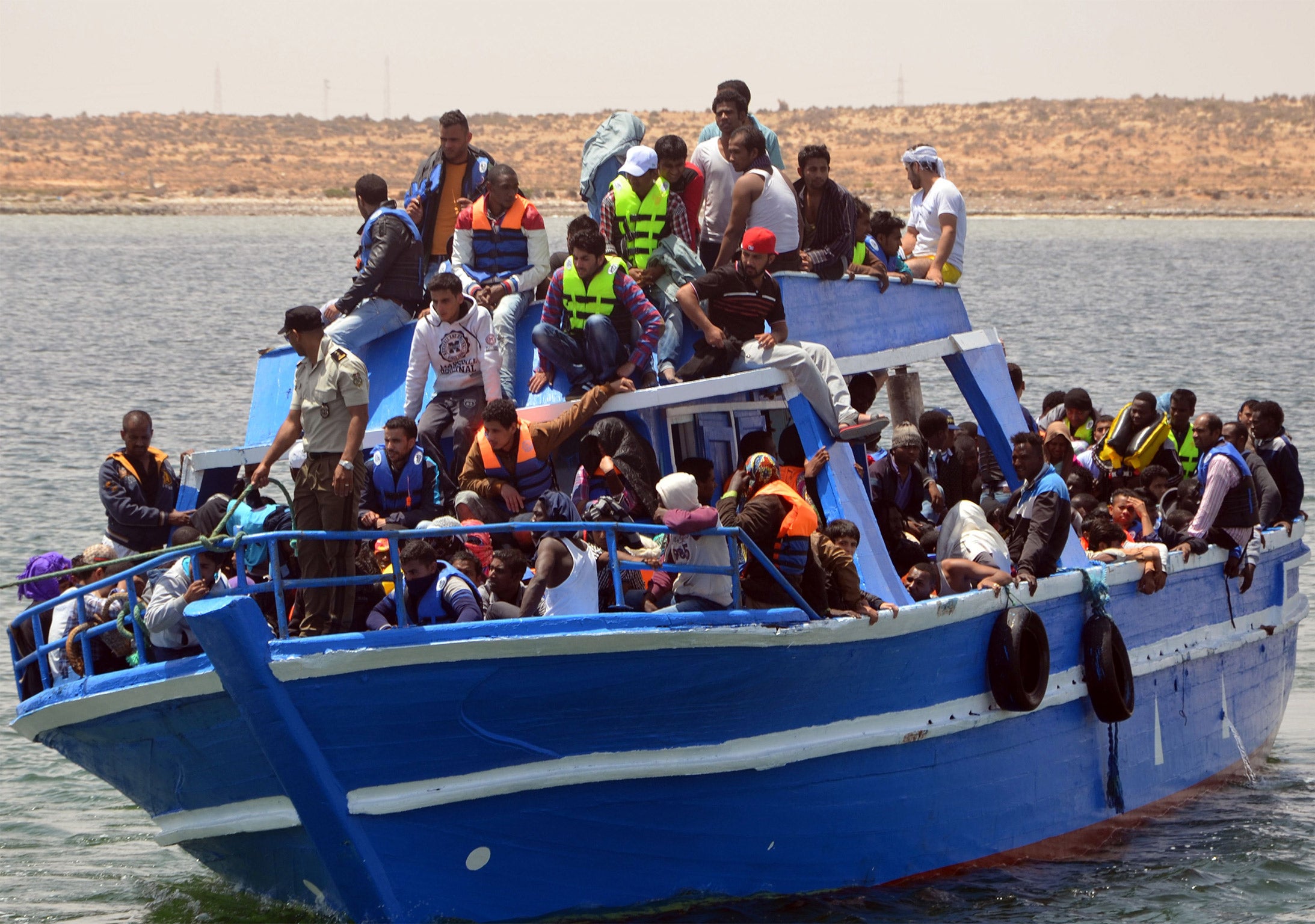 Migrants arrive at the port of Ben Guerdane, Tunisia, some 40 kilometres west of the Libyan border, after their vessel overturned, on Wednesday