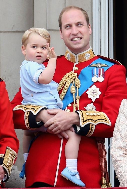 Prince George waves to crowds from the balcony at Buckingham Palace