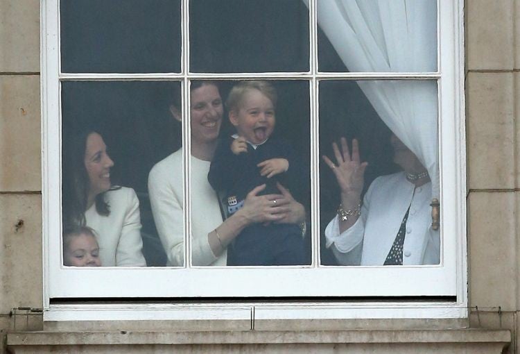 Prince George looked pleased with the amassed crowds outside Buckingham Palace