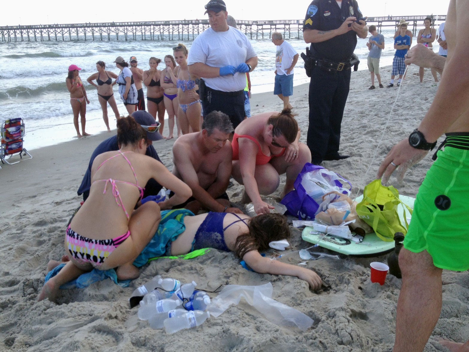 Emergency aid is given to a 14-year-old girl who was attacked by a shark off a beach in North Carolina