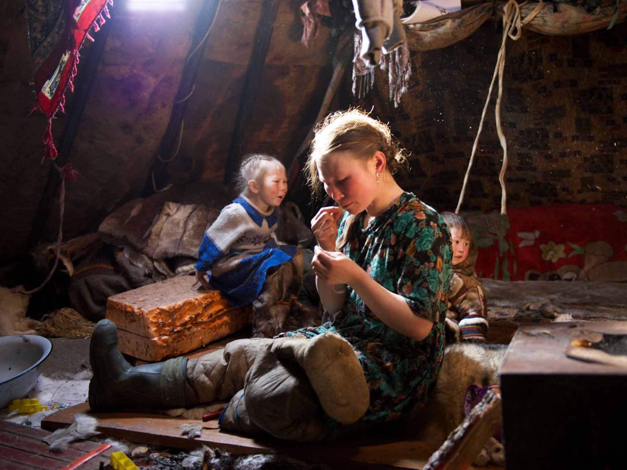 Nadia repairs a pair of boots