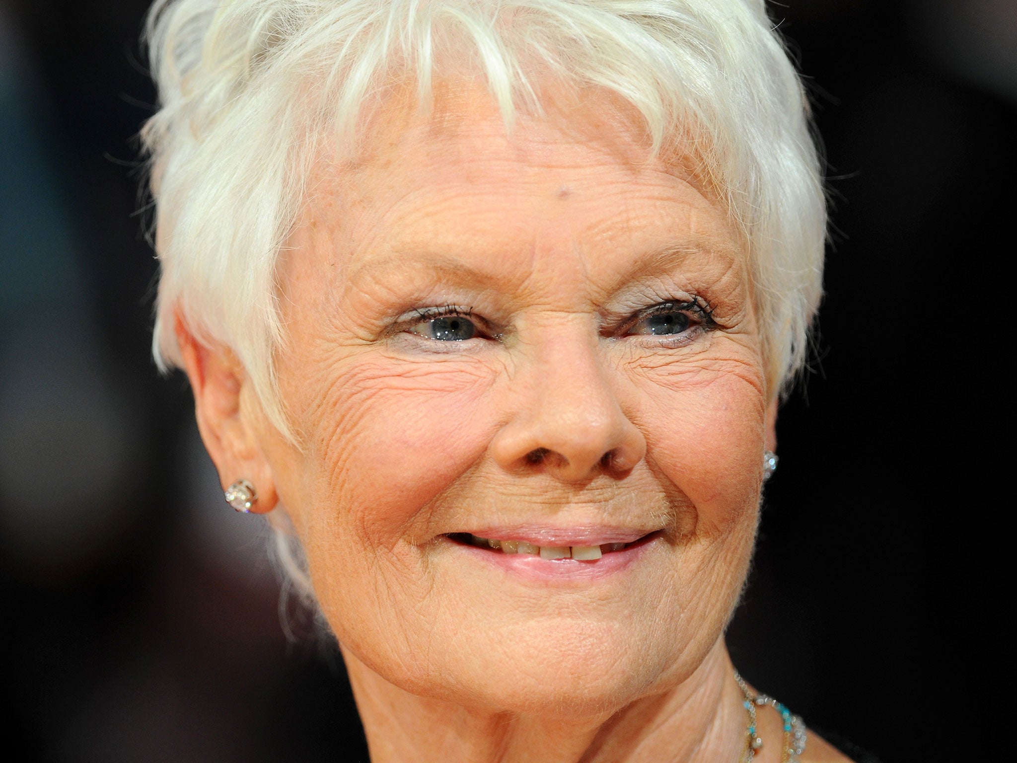 Judi Dench has refused to reveal the name of the director