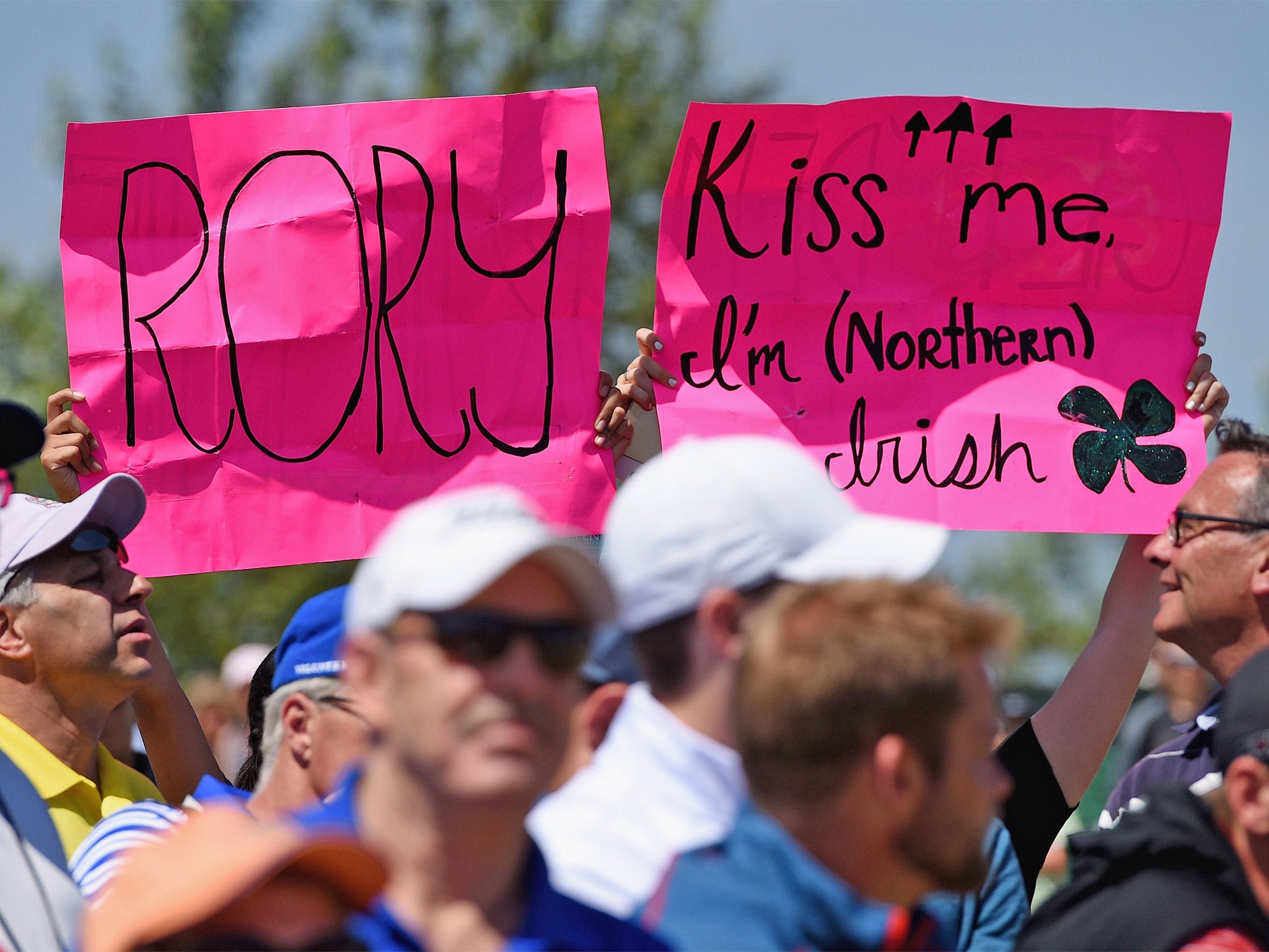 Admirers of Rory McIlroy do their best to get the attention of the world number one during his practice round at Chambers Bay (Getty)