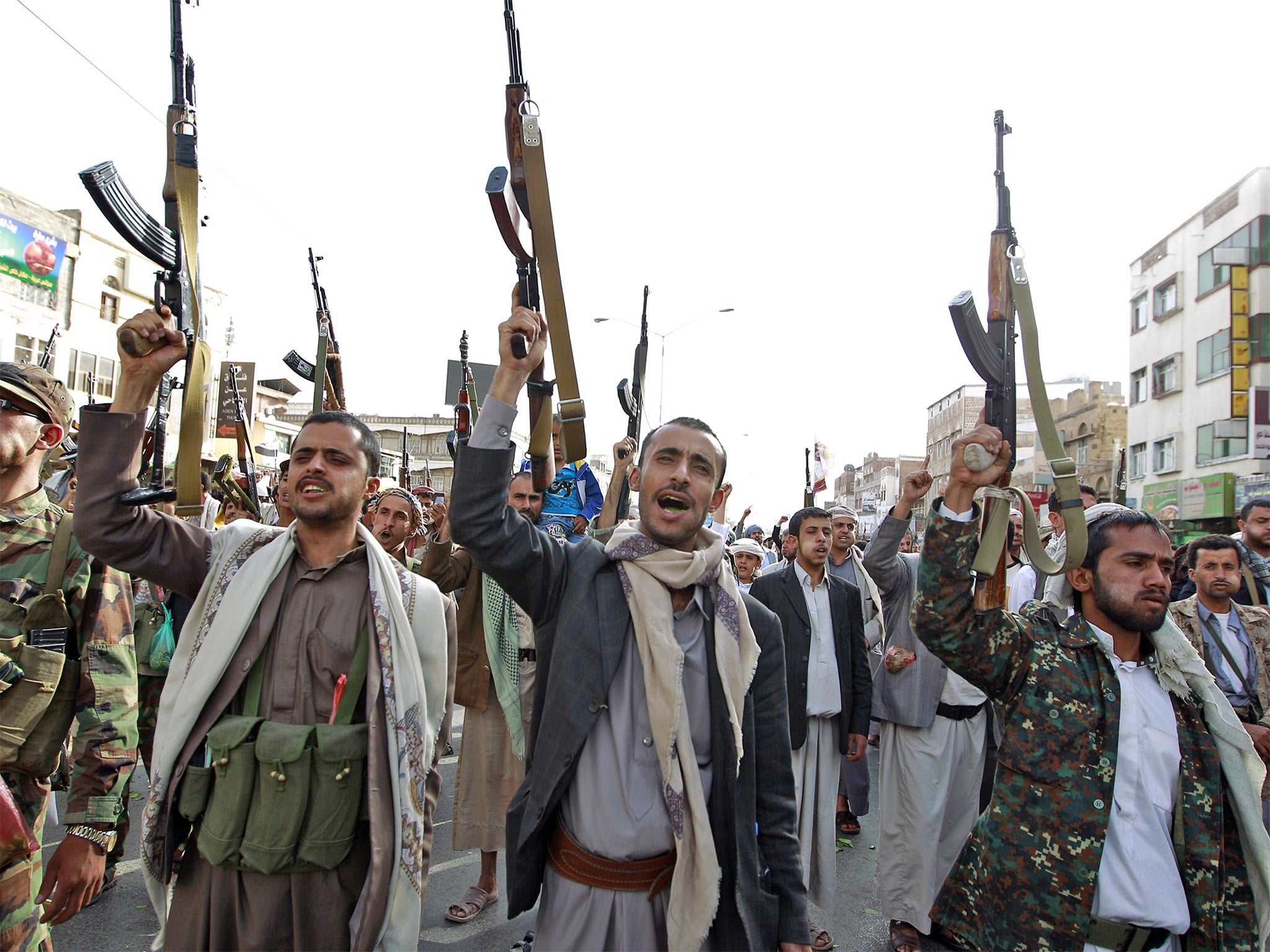 Huthi fighters raise their weapons during a recent rally in Sanaa