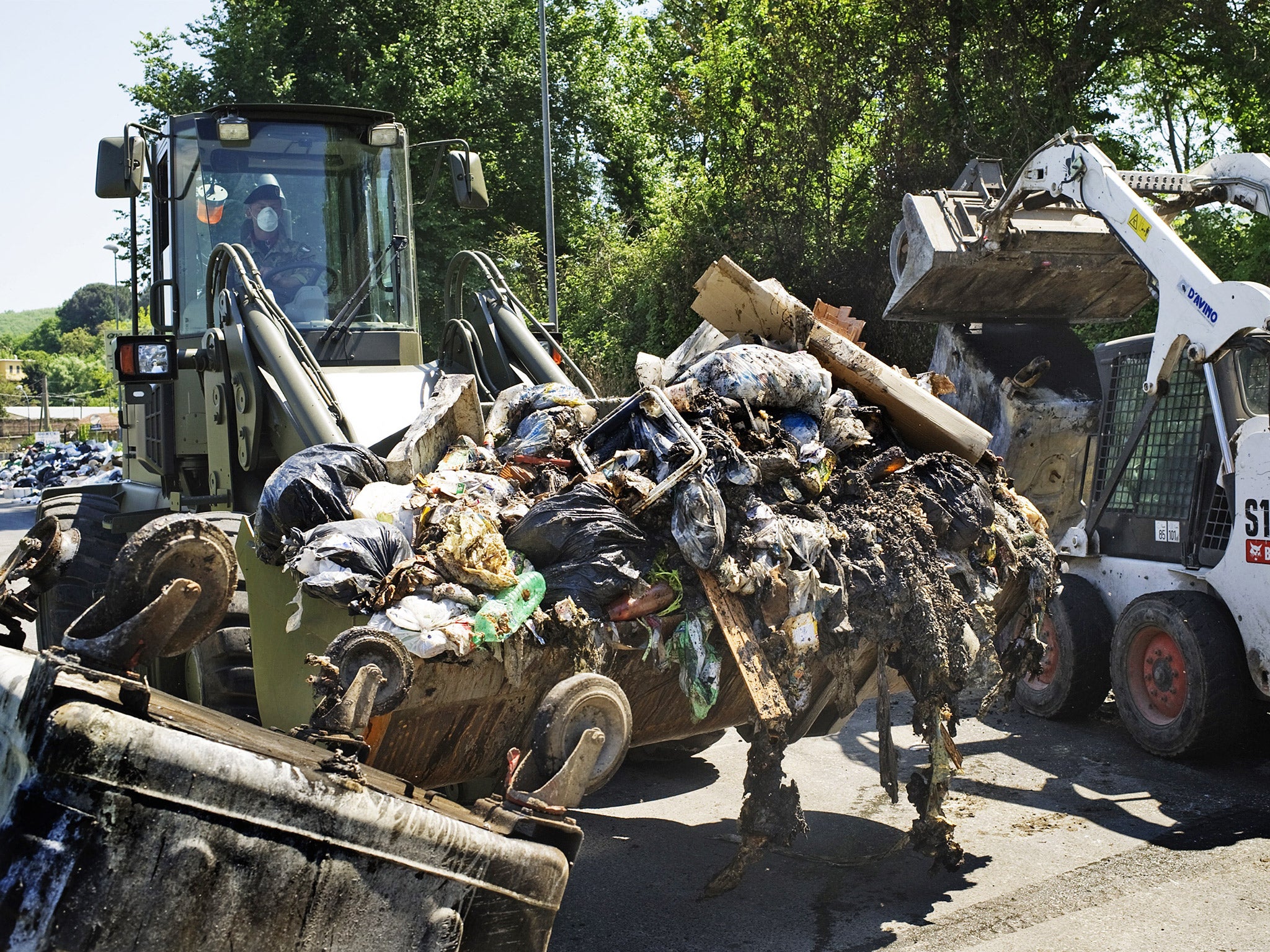 Italian soldiers collect garbage in a street near Naples in 2011. The region has long been dogged by waste disposal issues