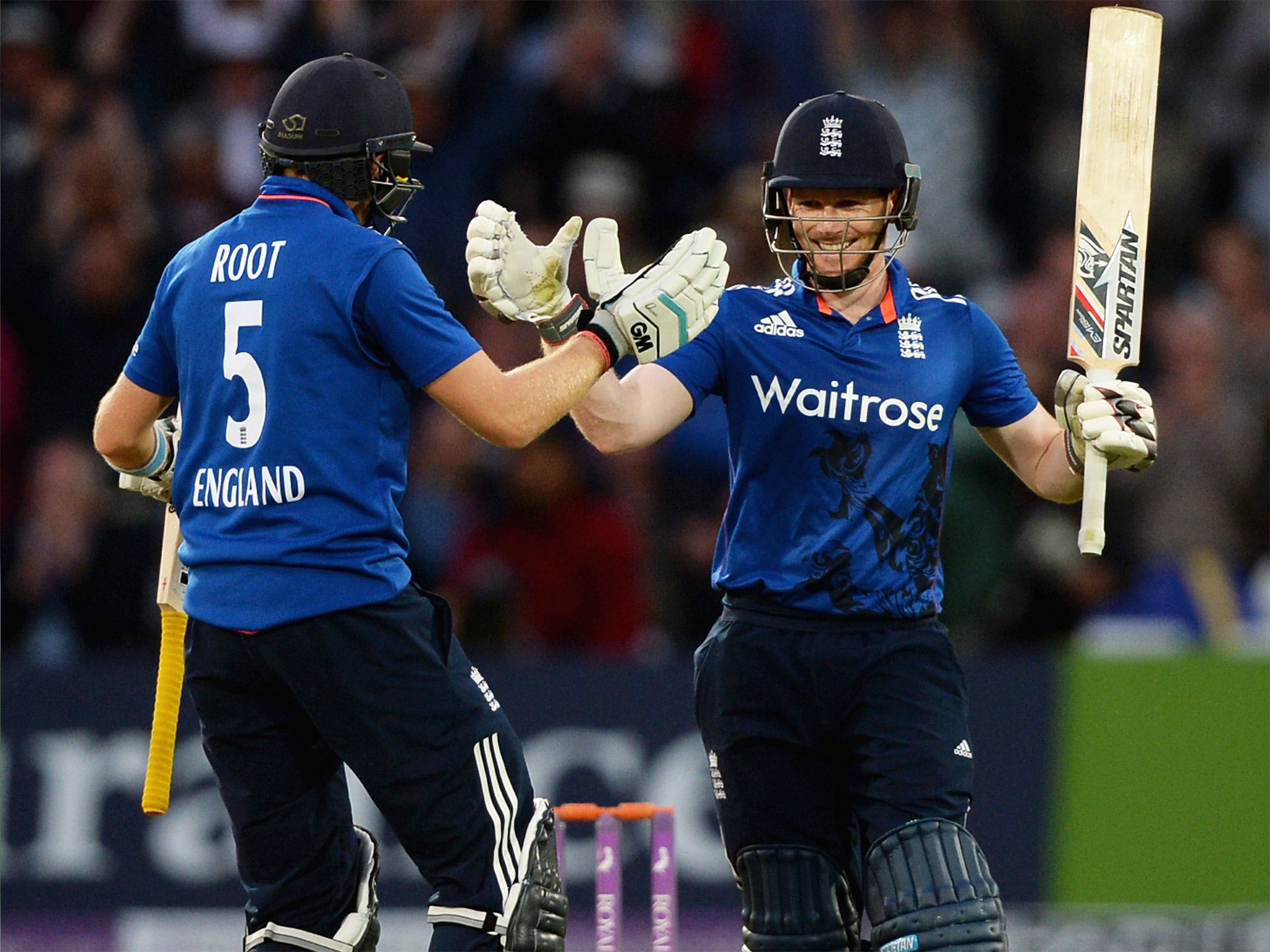 Joe Root congratulates England captain Eoin Morgan after he reached his century