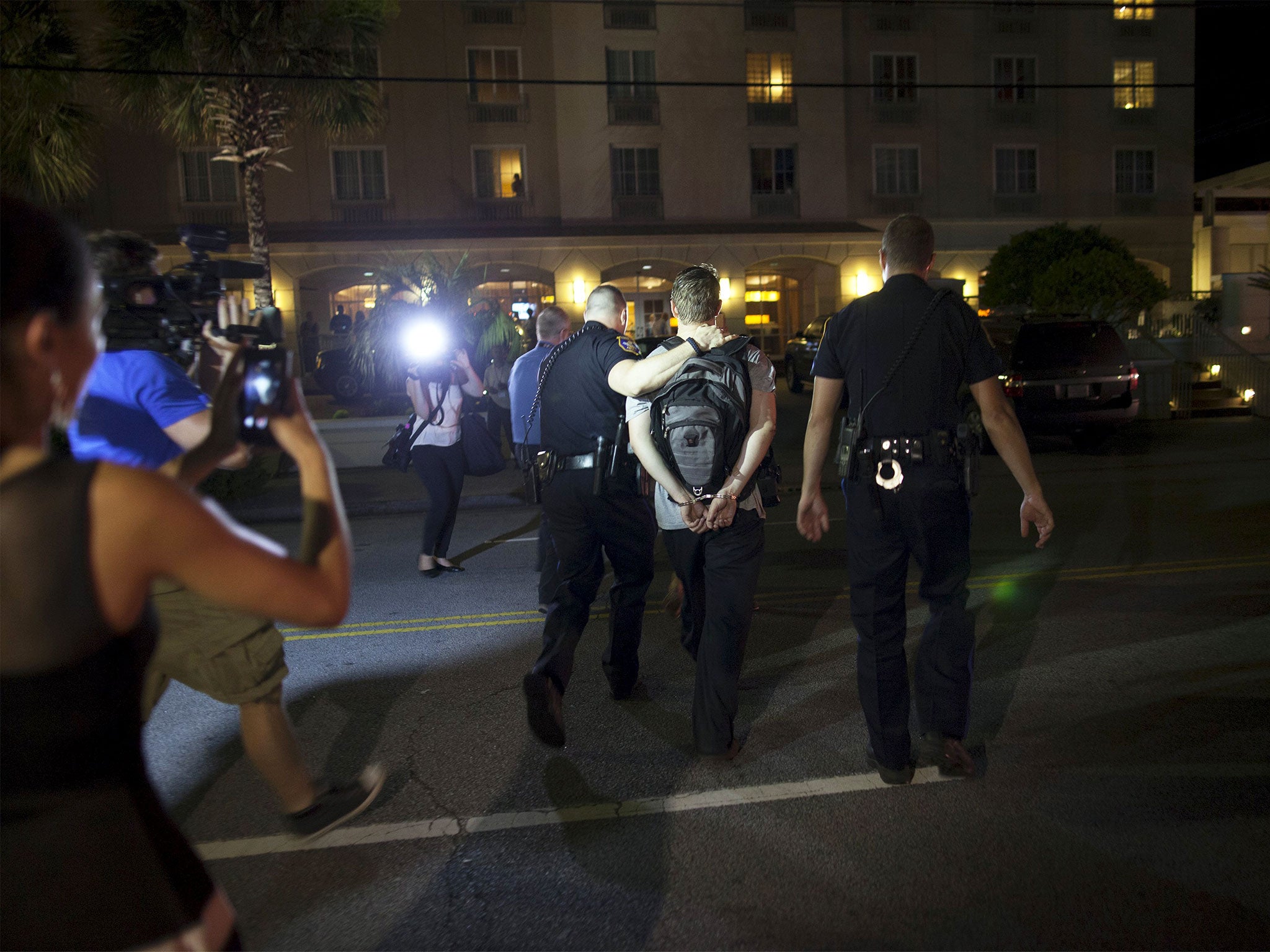 A photographer is detained as police respond to a shooting at the Emanuel AME Church in Charleston. A gunman opened fire at the historic African-American church in downtown Charleston. The photographer was later released