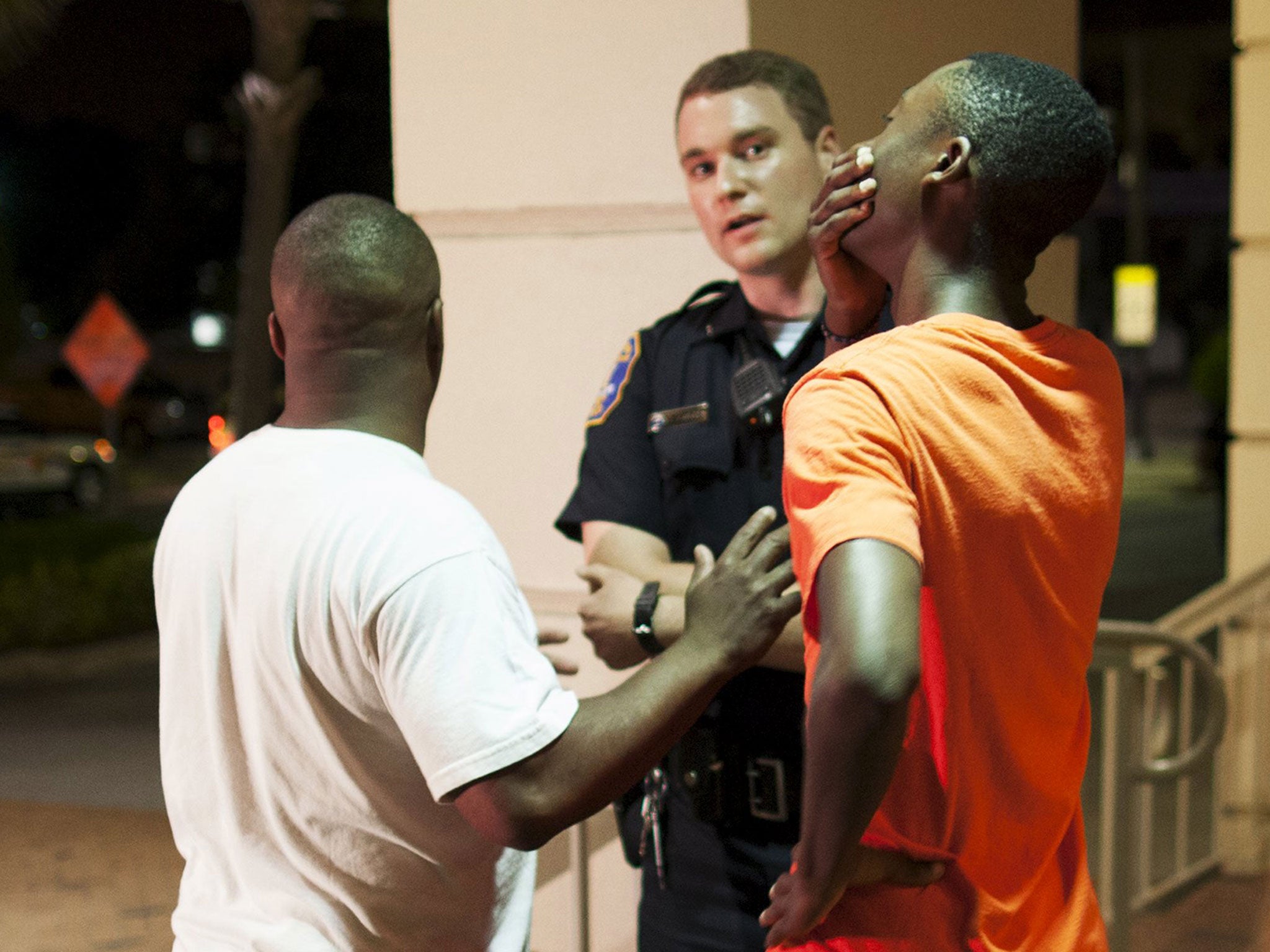 A man reacts while talking to police officer