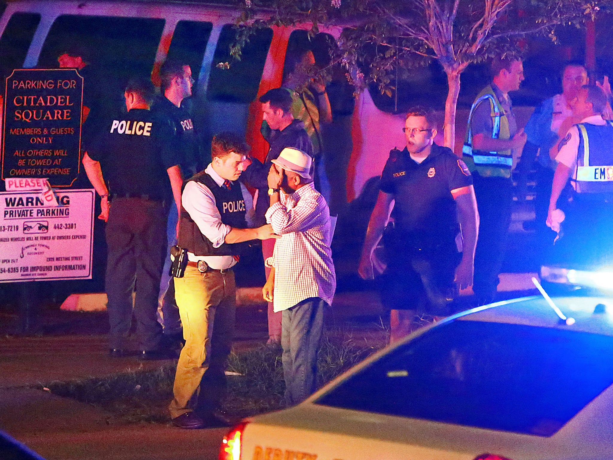 Police talk to a man outside the Emanuel AME Church following a shooting