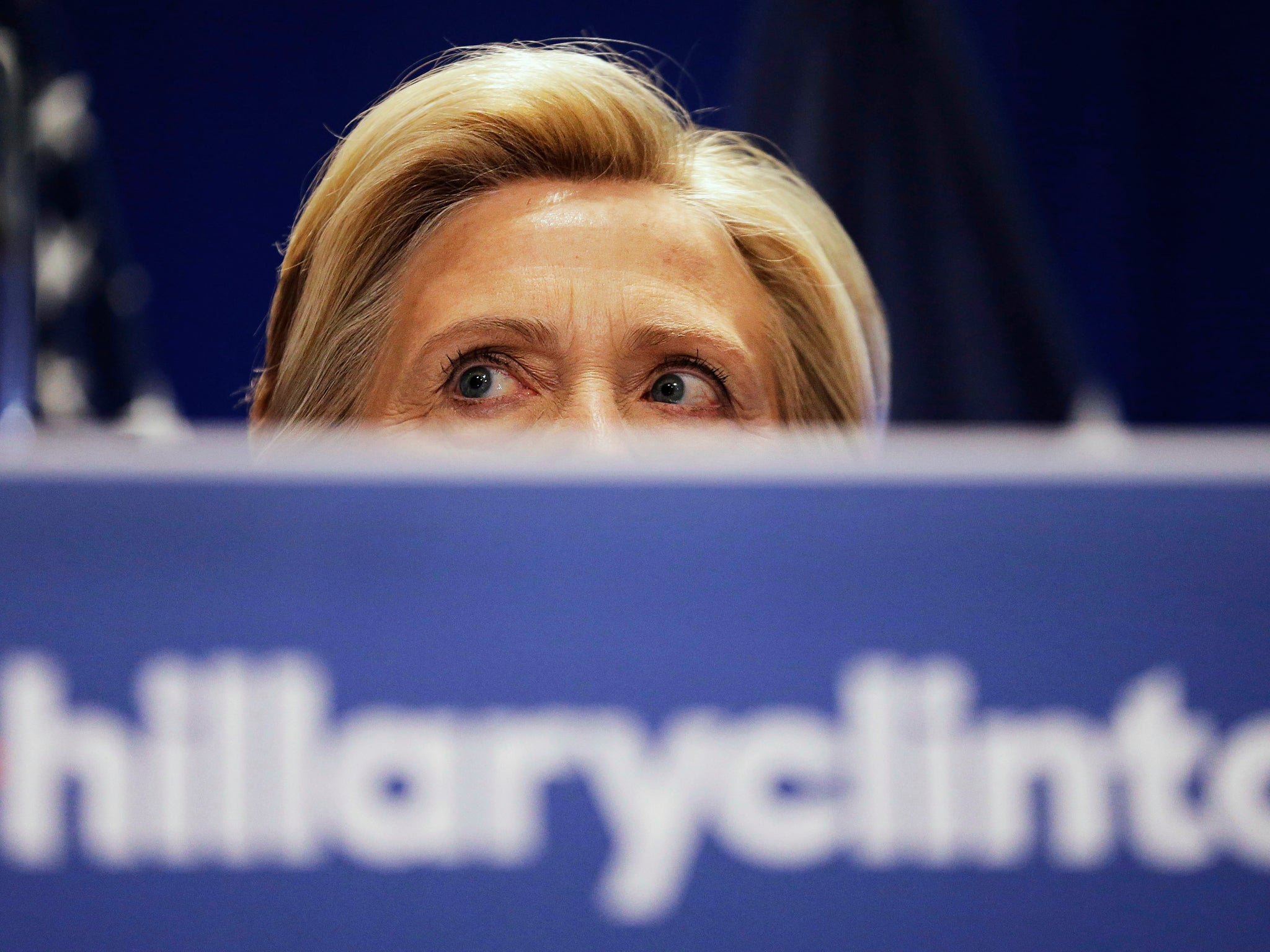 Hillary Clinton peers over a podium while addressing an audience on the campaign trail in North Charleston.