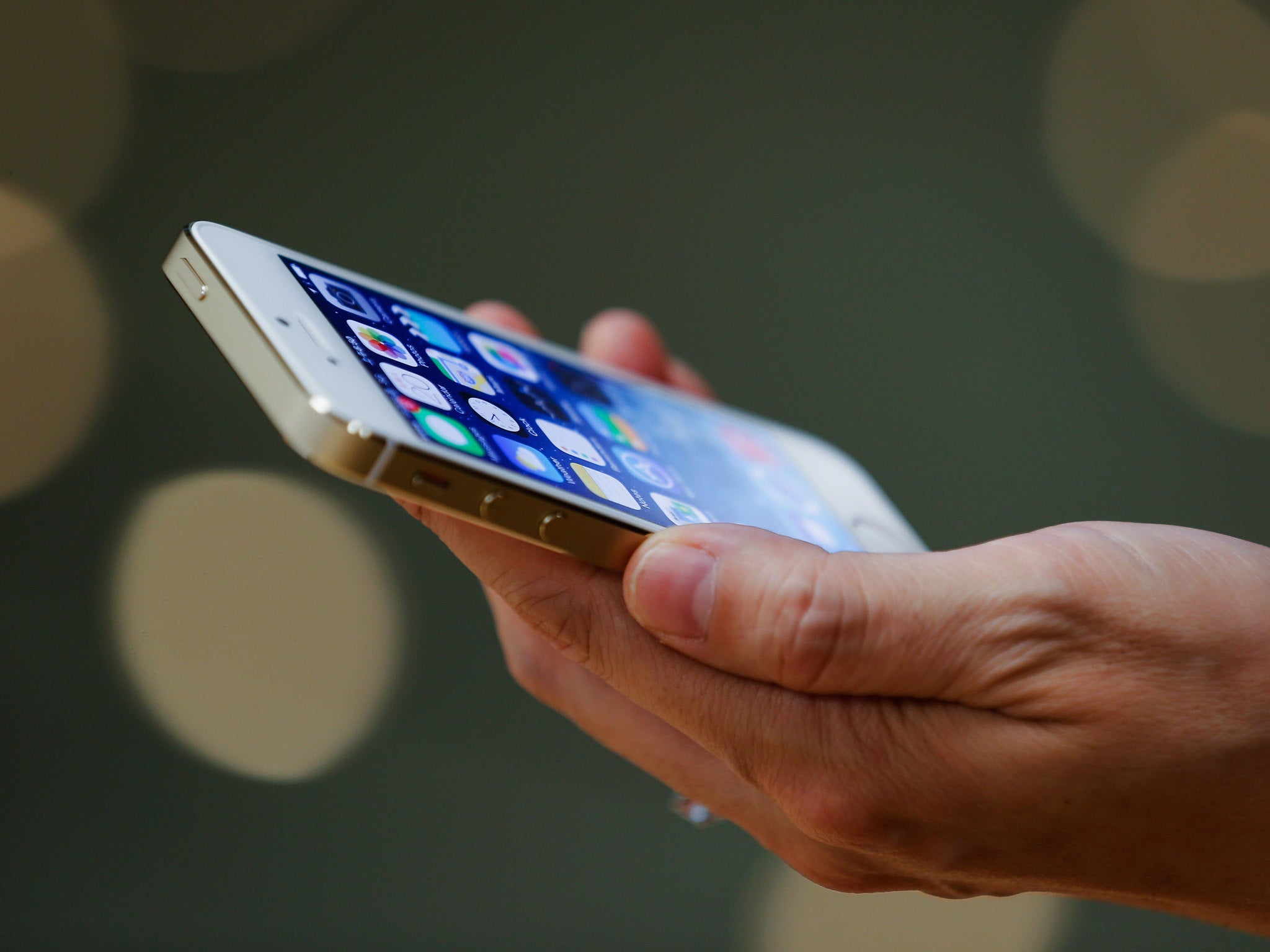 A customer inspects the new iPhone at the Wangfujing flagship store on September 20, 2013 in Beijing, China