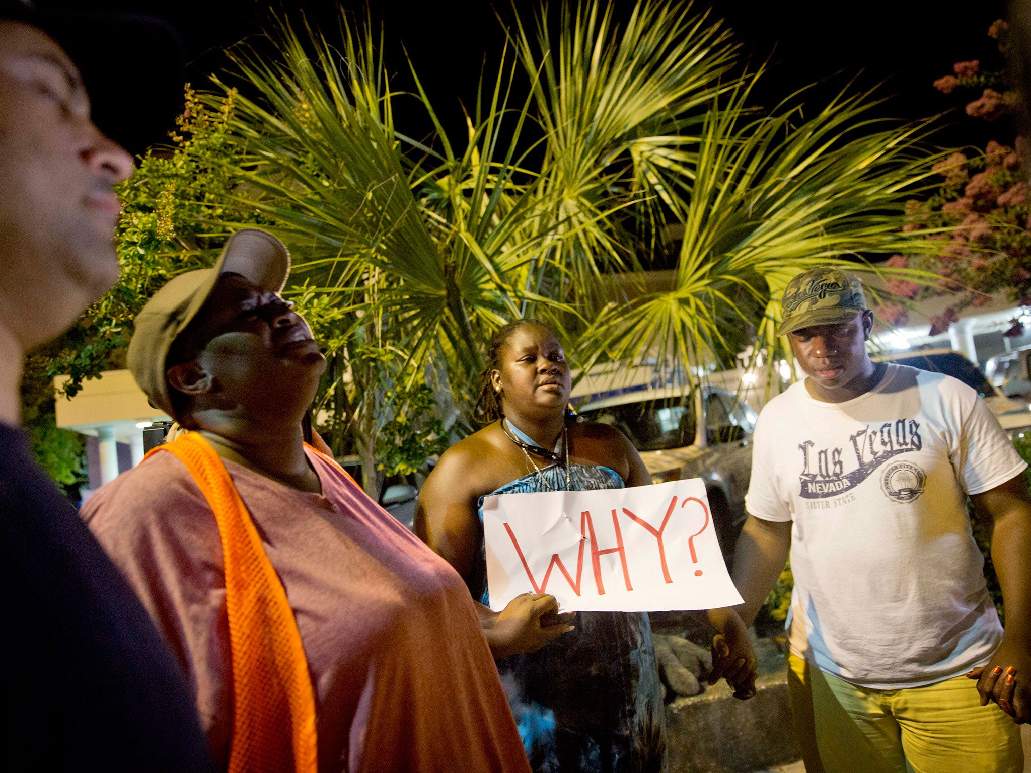 Surreace Cox, of North Charleston, holds a sign during a prayer vigil down the street from the Emanuel AME Church