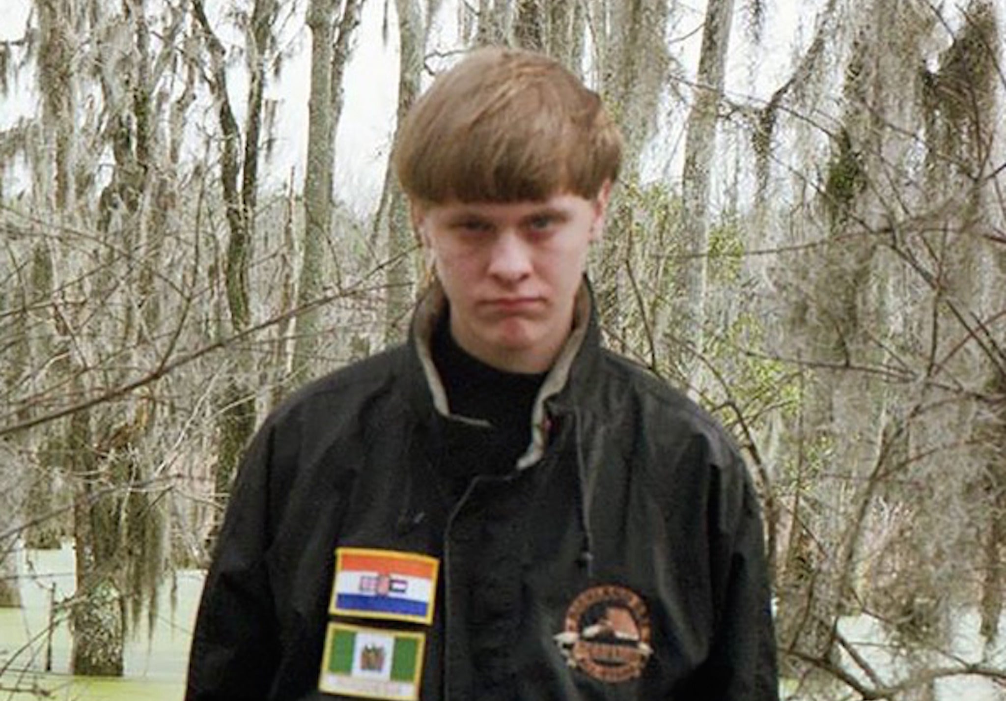 Dylann Roof poses in a Facebook picture showing Rhodesian and Apartheid flags on his jacket