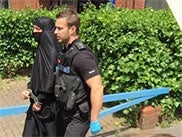 A man being led off by the police in Watford