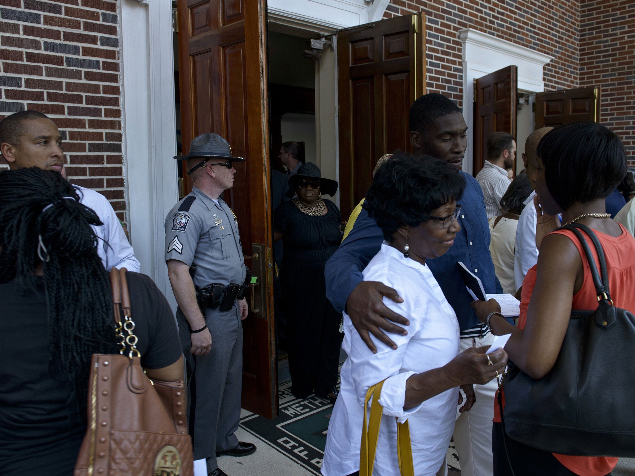 People leave Morris Brown Church after the vigil, which was disrupted by a bomb scare, that was quickly cleared by police.