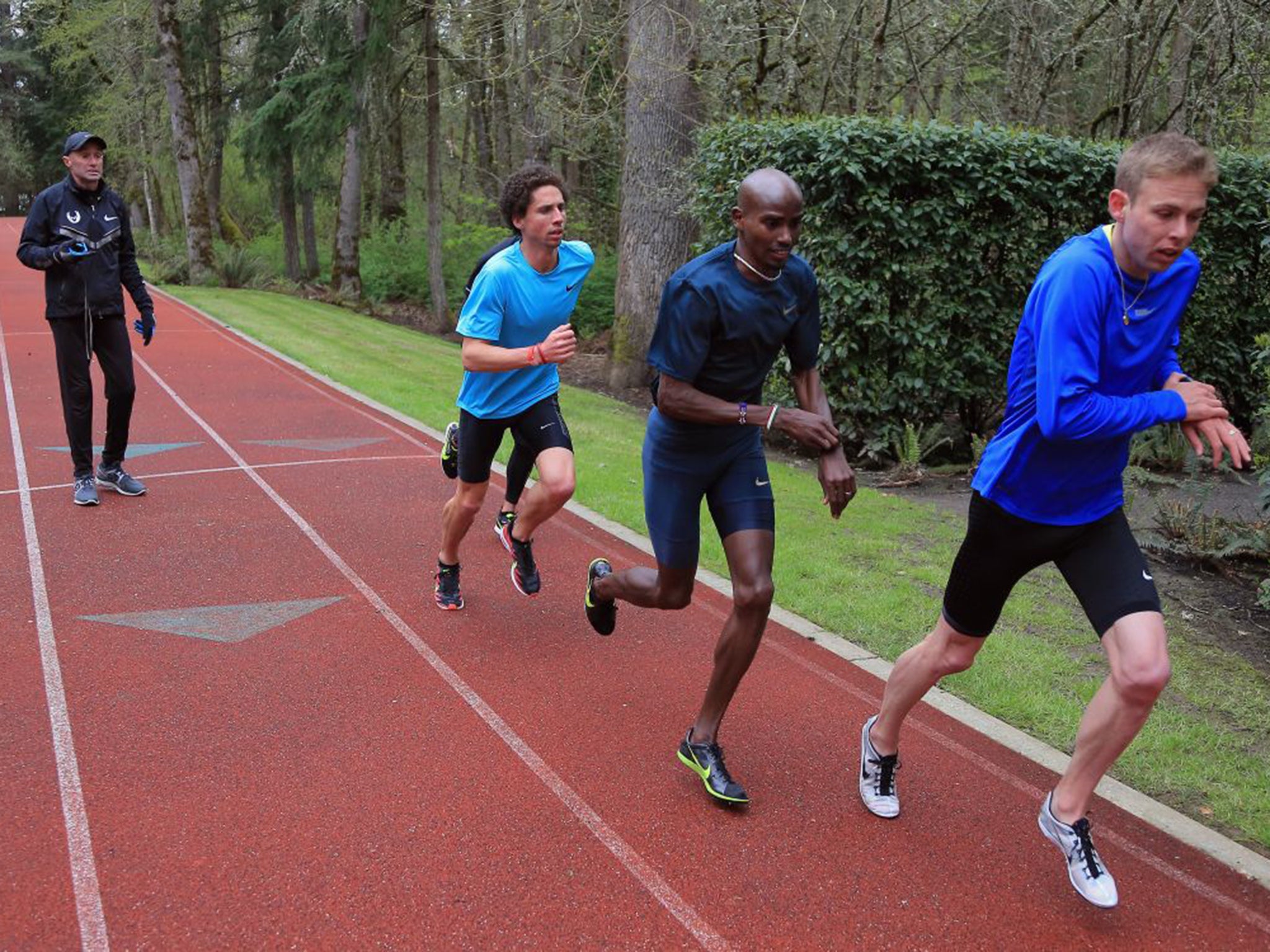 Alberto Salazar, left, watches (from left) Cam Levins, Mo Farah and Galen Rupp as they train at the Nike Oregon Project in 2013