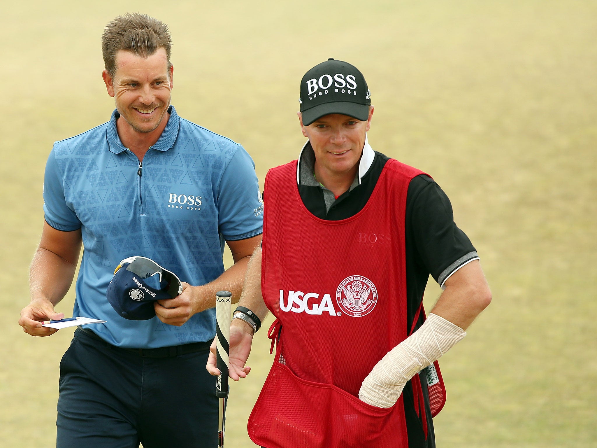 Stenson and caddie Gareth Lord sporting his injured left wrist