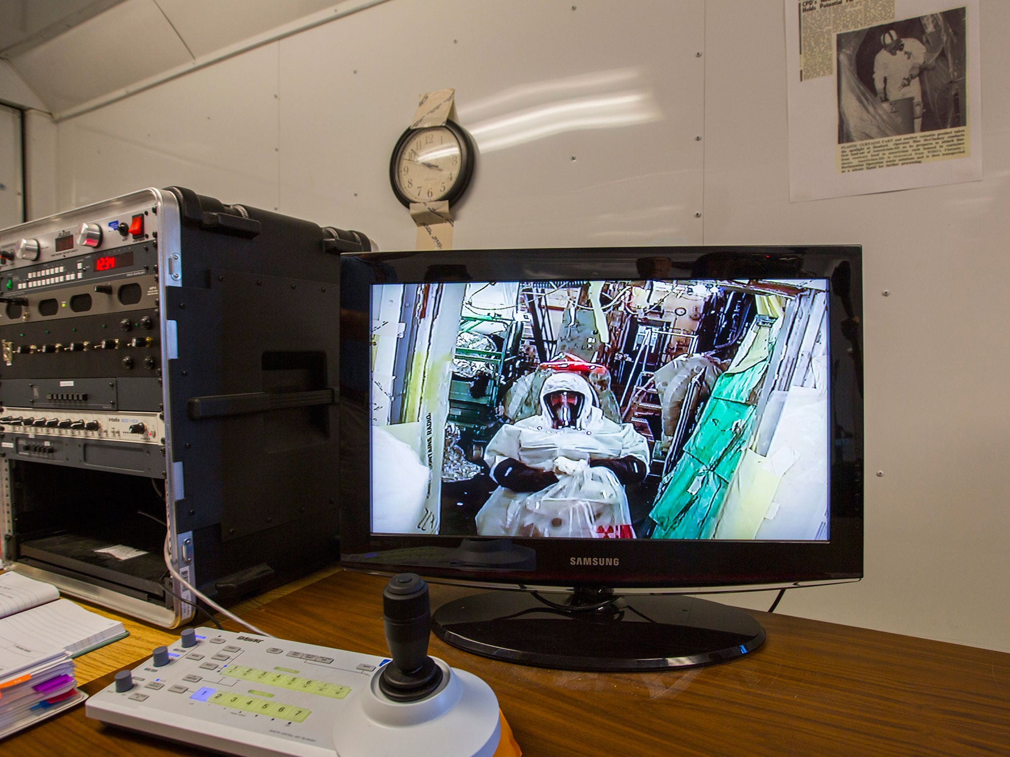 A Hanford worker is seen on a TV monitor in a level B protective suit as he cleans the most hazardous room at the Hanford Site, the Plutonium Finishing Plant's Americium Recovery Facility, also known as the 'McCluskey Room,' in Hanford, Washington