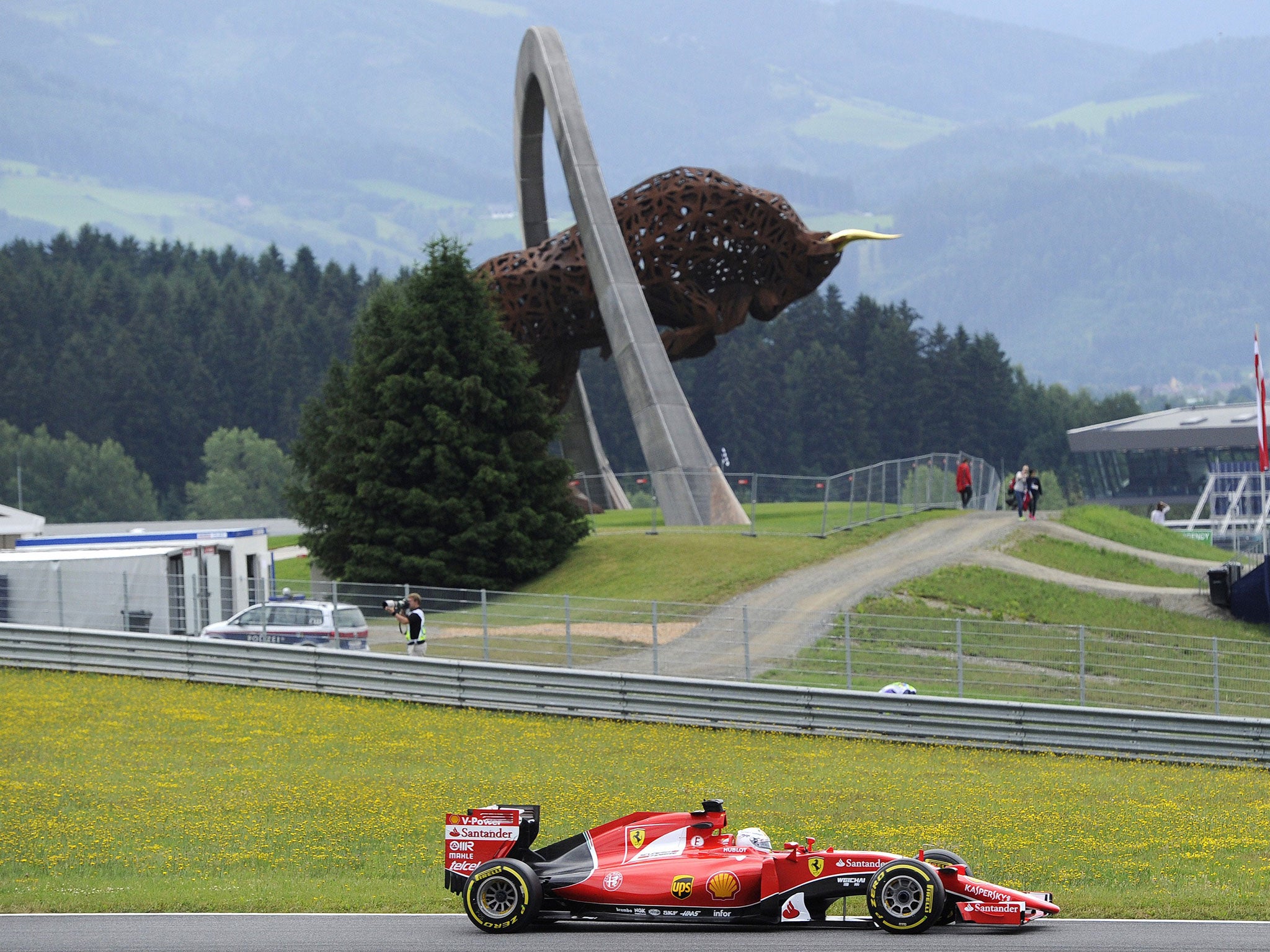 The Red Bull Ring's famous 'Bull' landmark as Sebastian Vettel flashes past