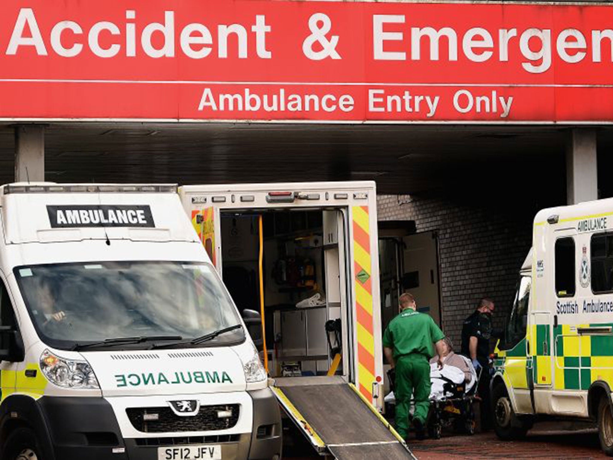 People are tended to near the ambulances parked at the entrance to Glasgow Royal Infirmary