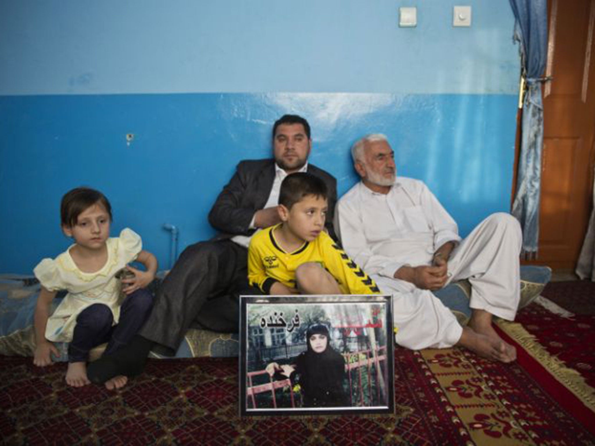 Members of Farkhunda’s family including her father (far right) at their home in Kabul