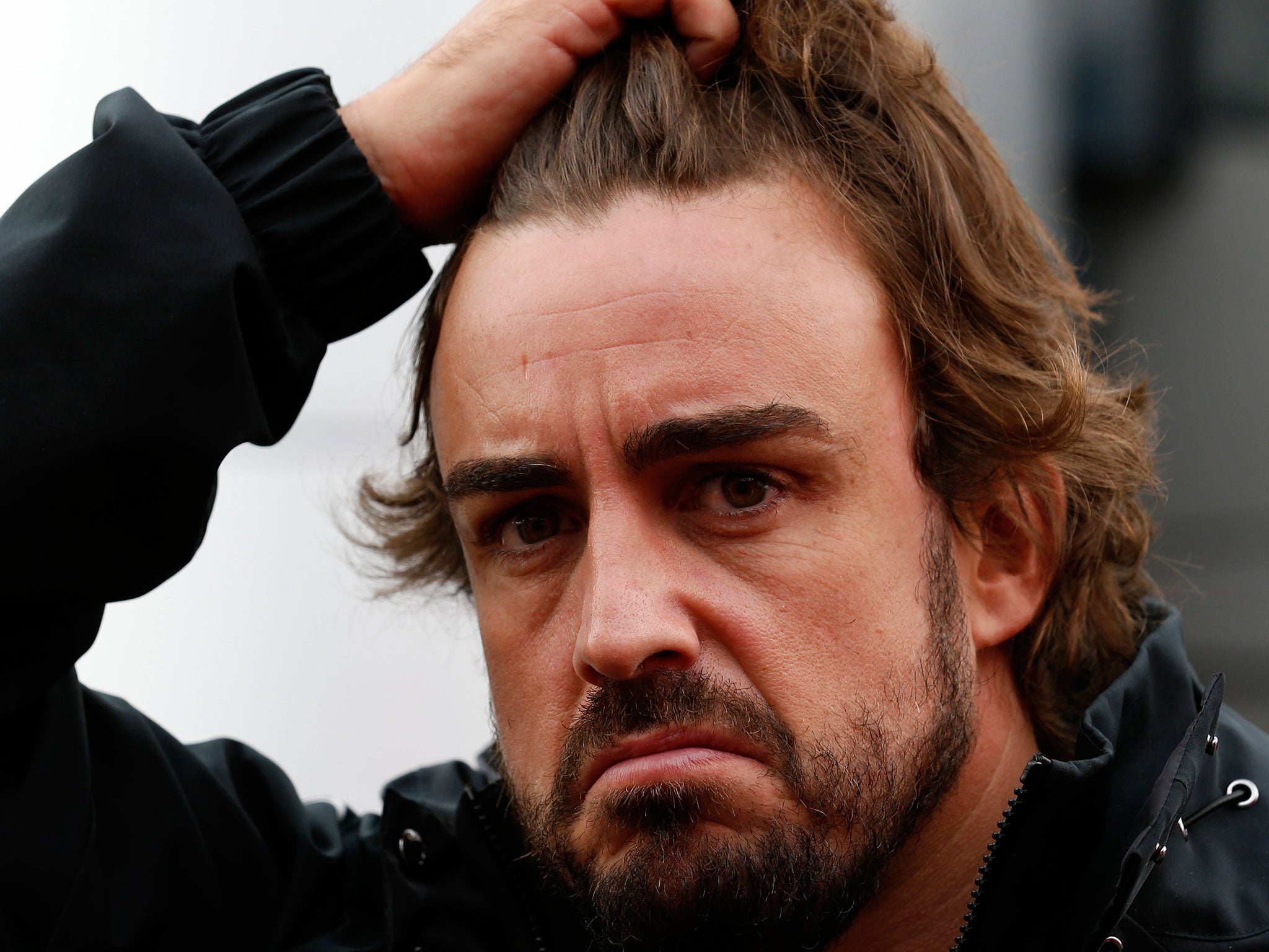 McLaren's Fernando Alonso reacts during practice