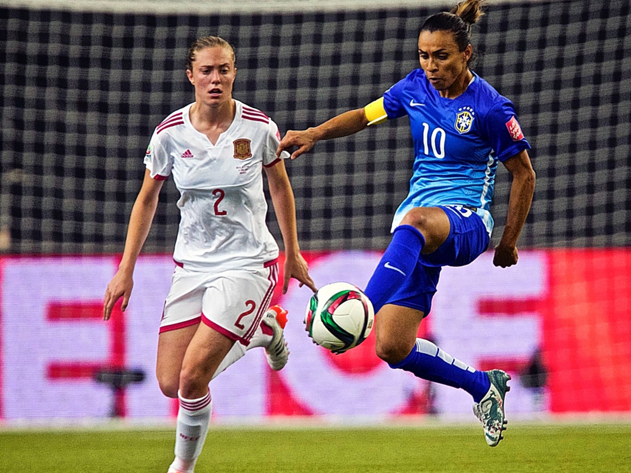 Brazil forward Marta (in blue) has fought prejudice ever since her brothers beat her up for playing football