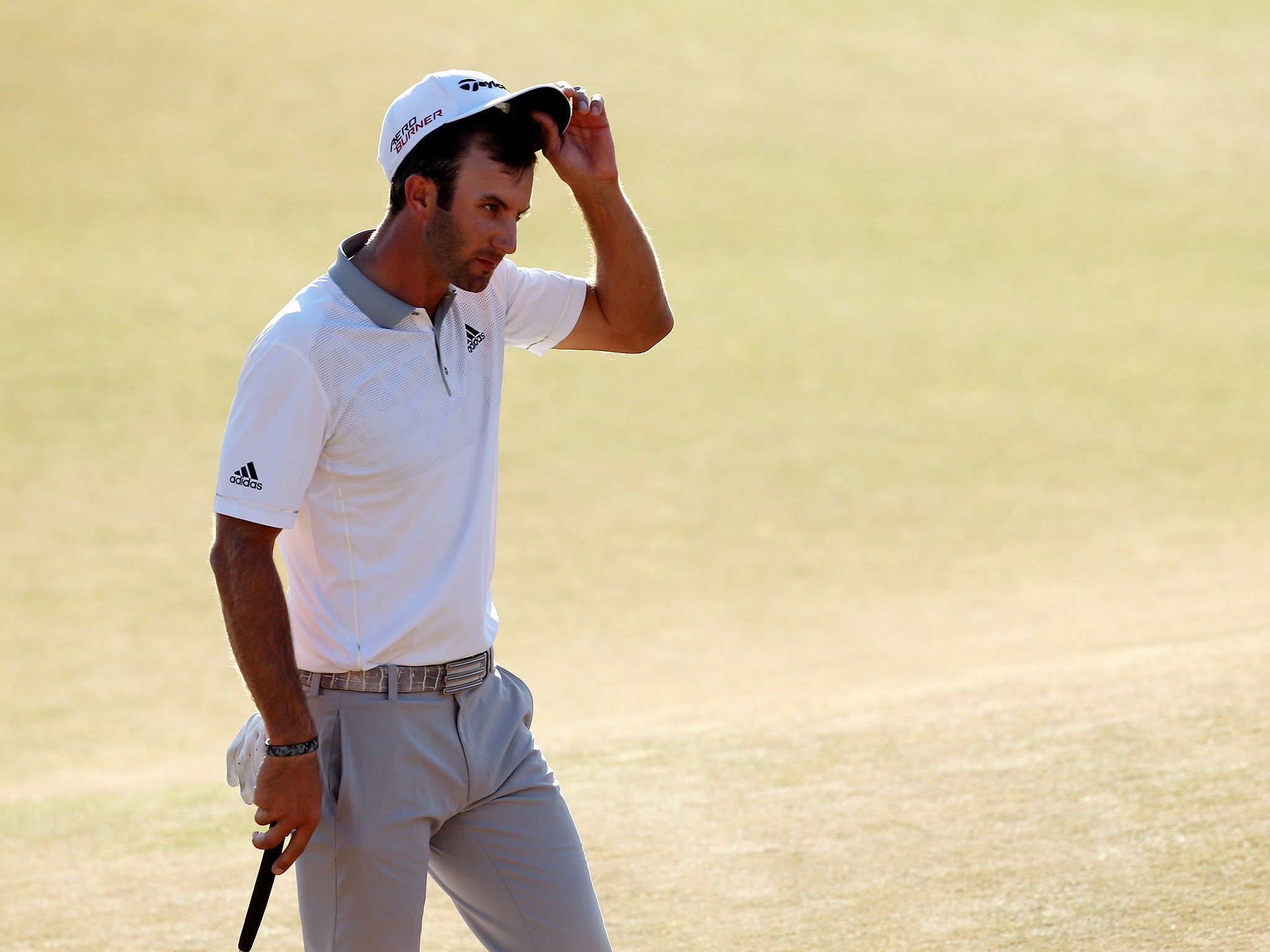 Johnson walks off the green at 18 after his agonising loss