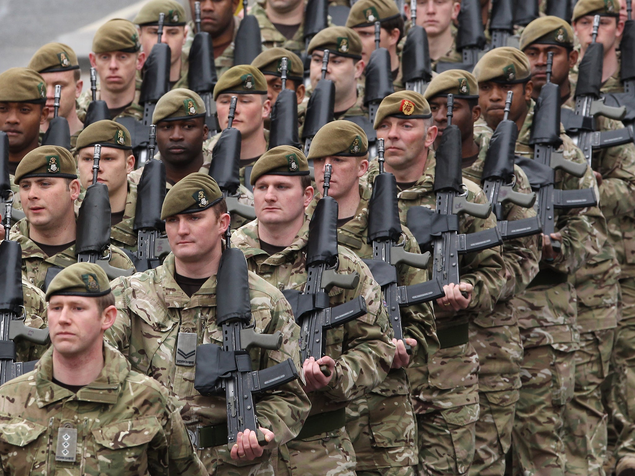 British soldiers carrying the SA80 rifle