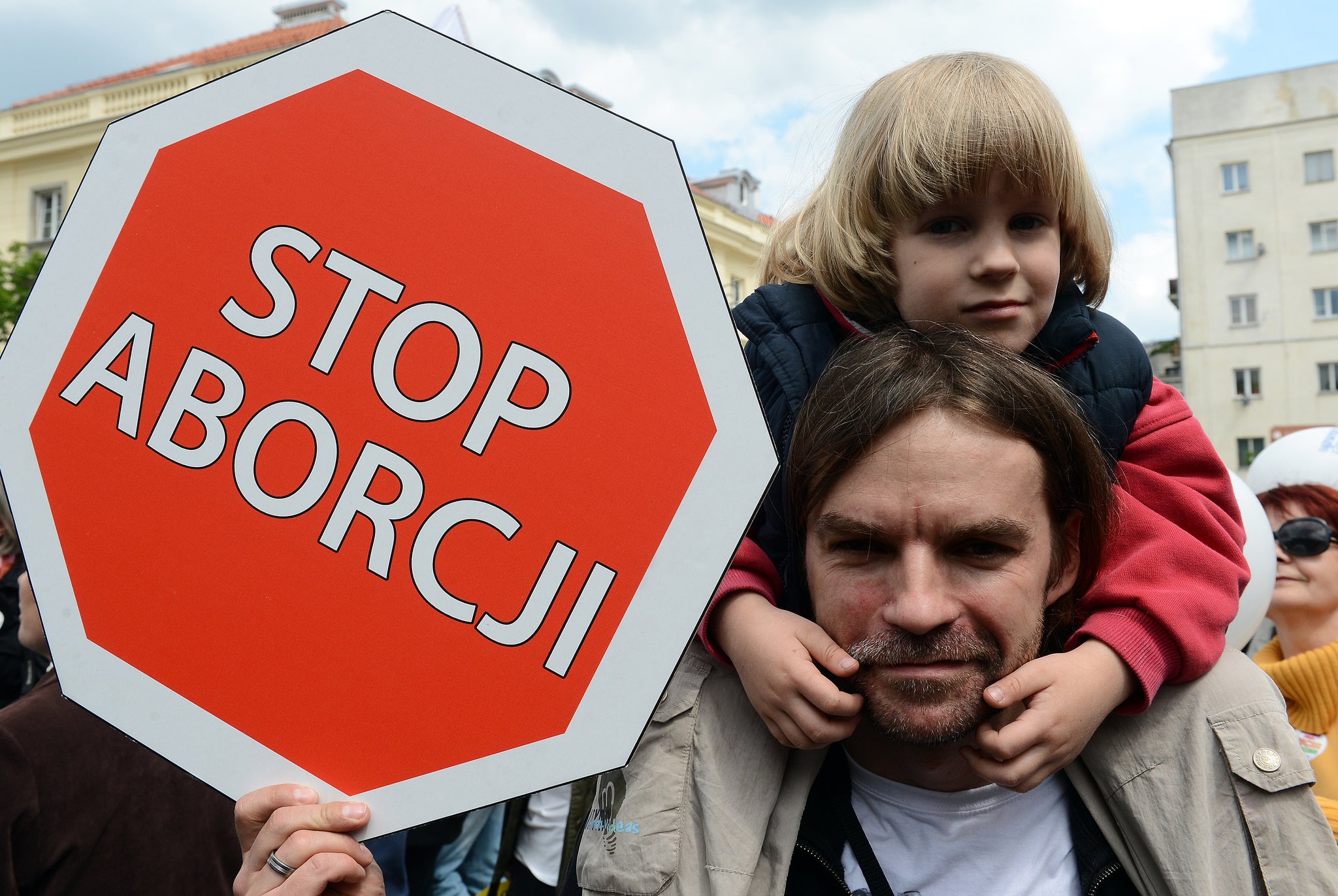 Father holds a 'stop abortion' poster in Warsaw as part of the capital's pro-family demonstration in 2013