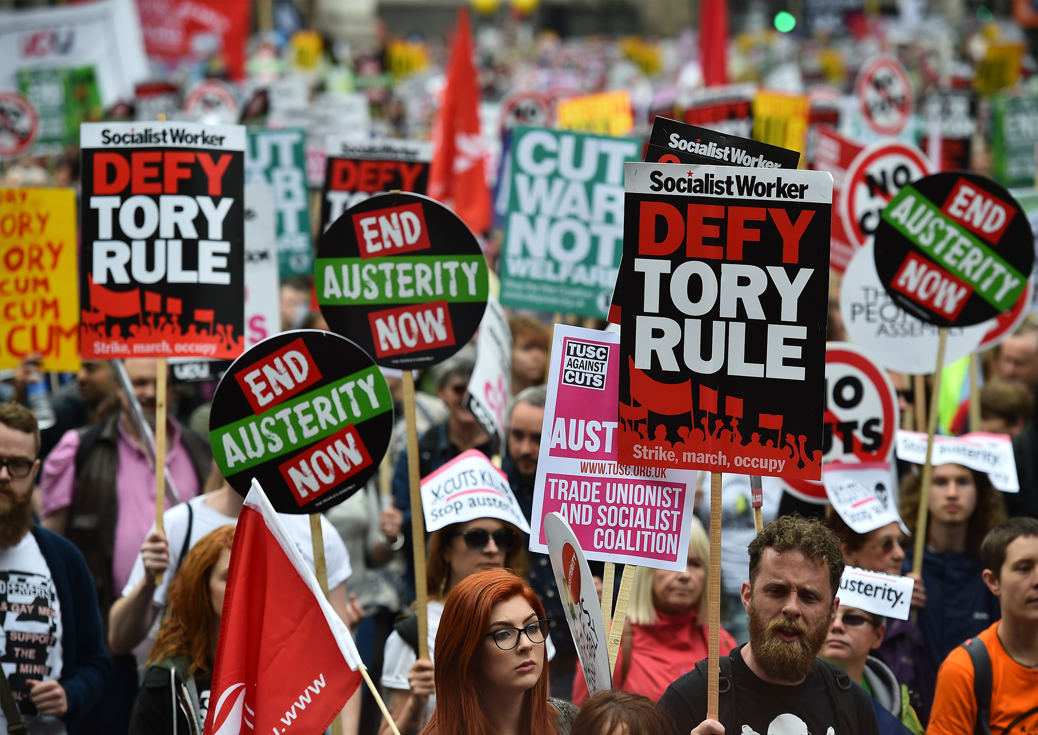 Demonstrators march to protest against the British government's spending cuts and austerity measures in London on June 20, 2015