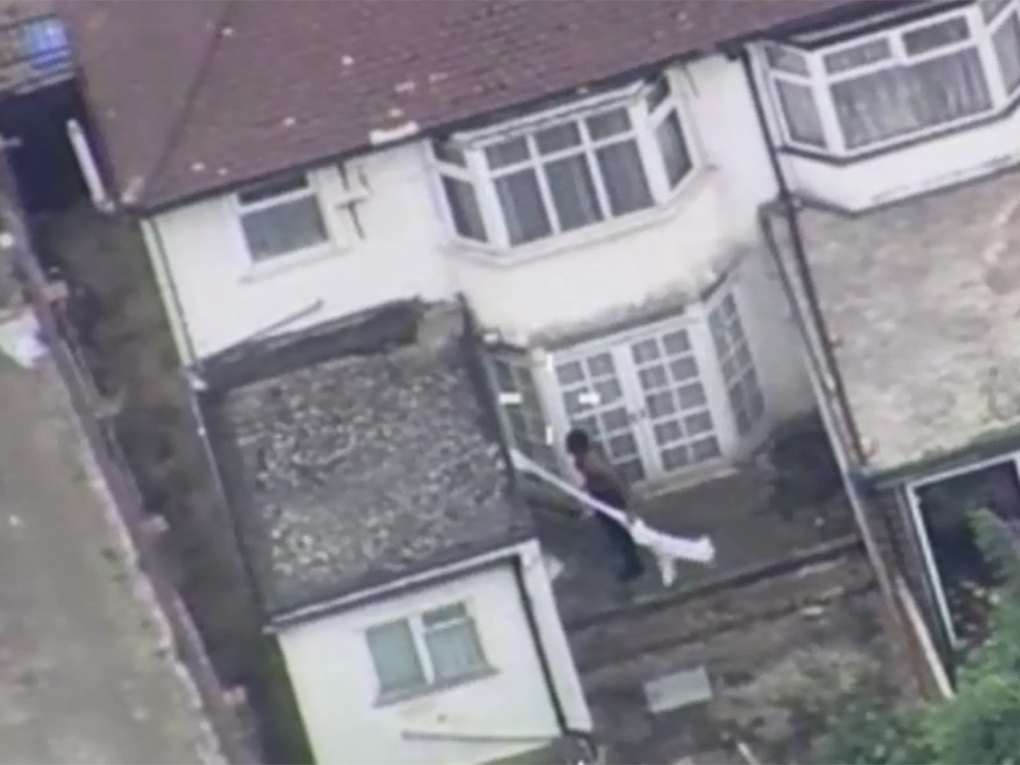 The cage fighter can be seen smashing the back door of a house and entering the property.