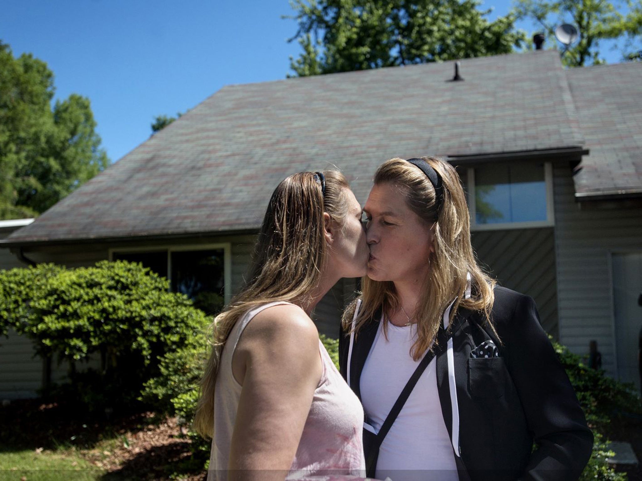 Beck, right, kisses her fiancee, Heather Stott