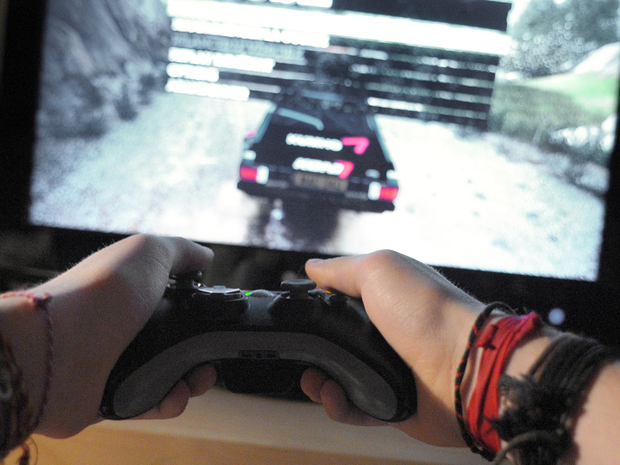 A young boy plays on his video game in Paris on January 21, 2010. AFP PHOTO ERIC PIERMONT