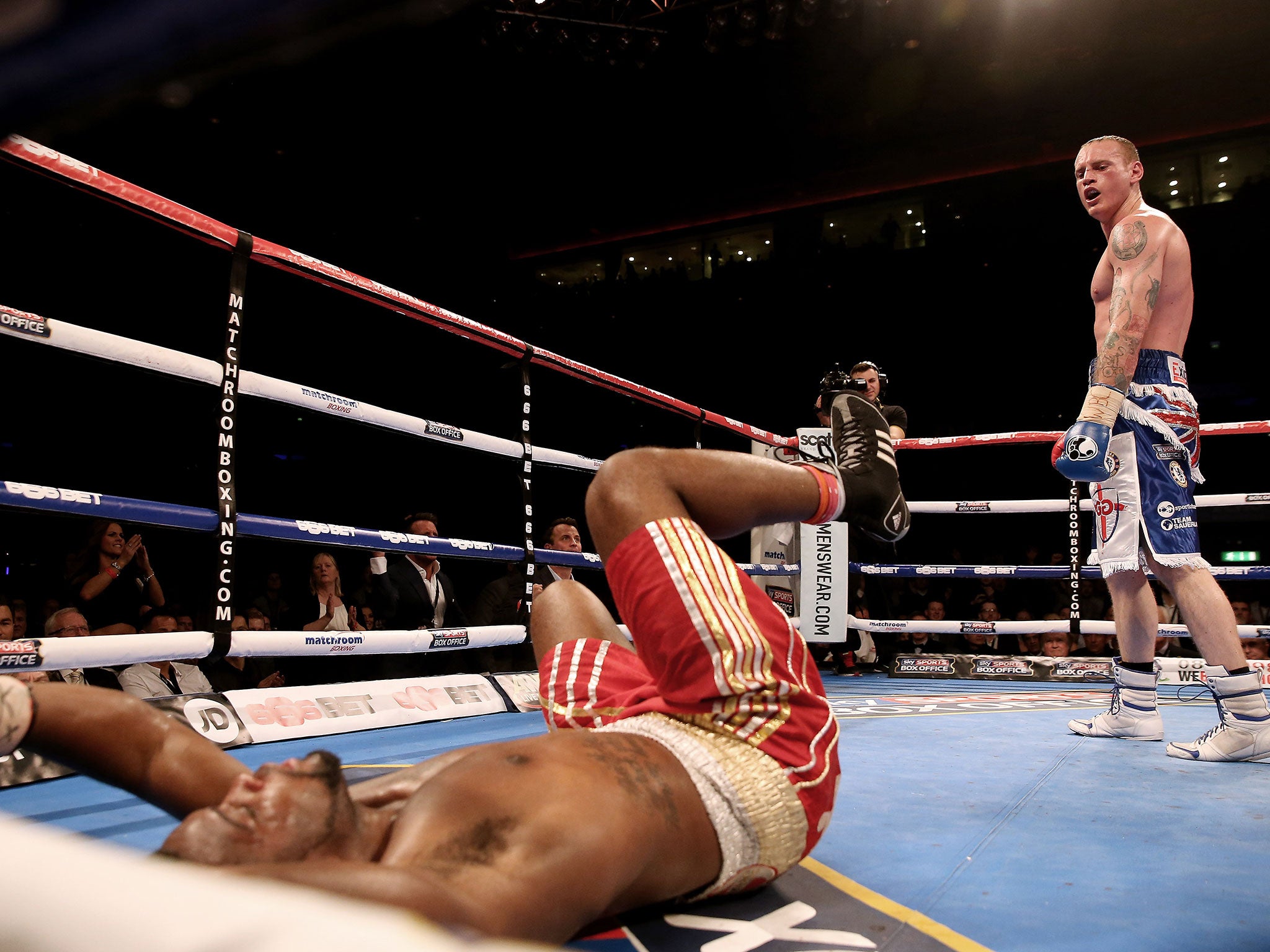 Groves stands over Denis Douglin after knocking him down