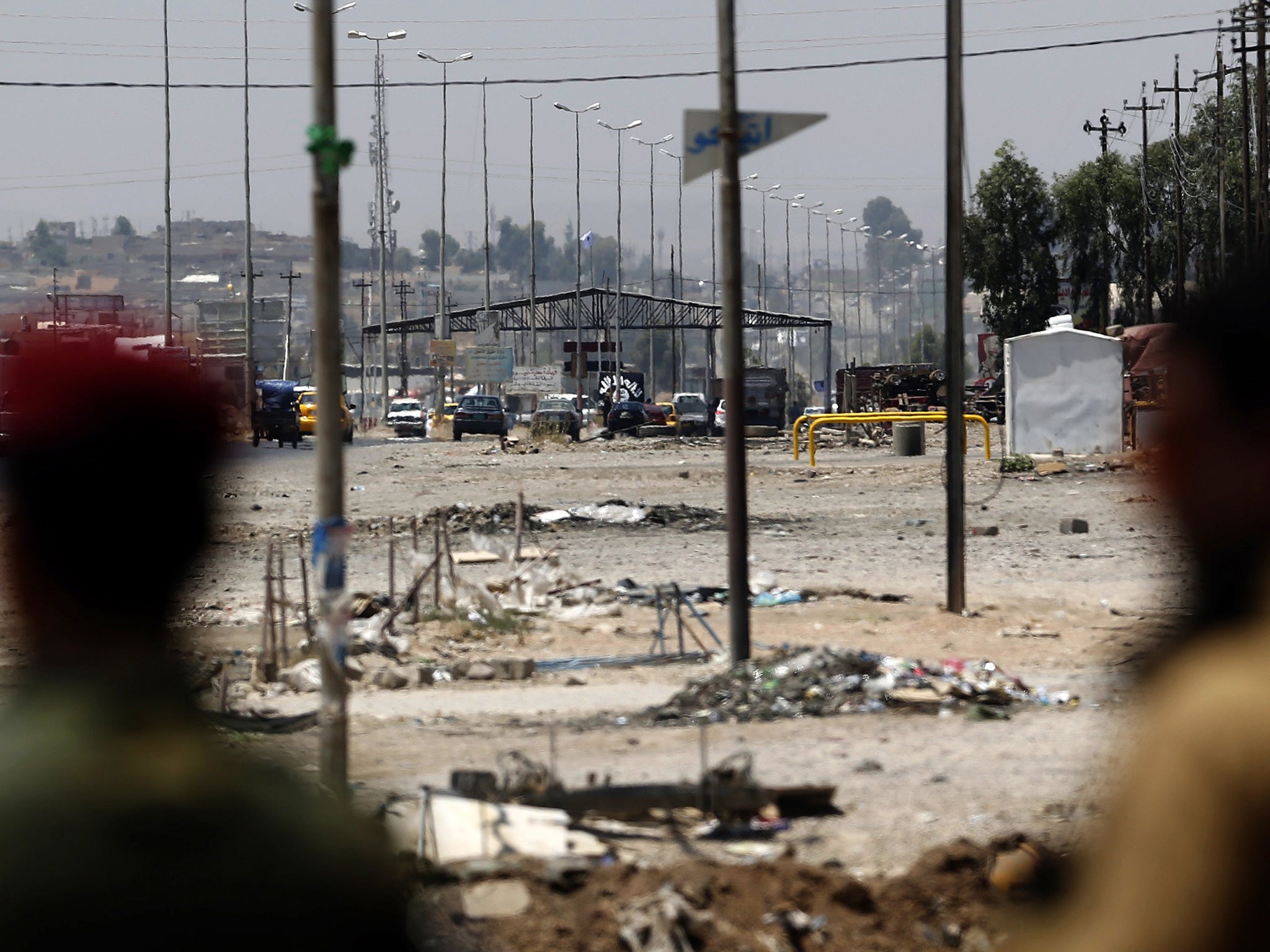 Kurdish troops watch Isis positions in Mosul (AFP)